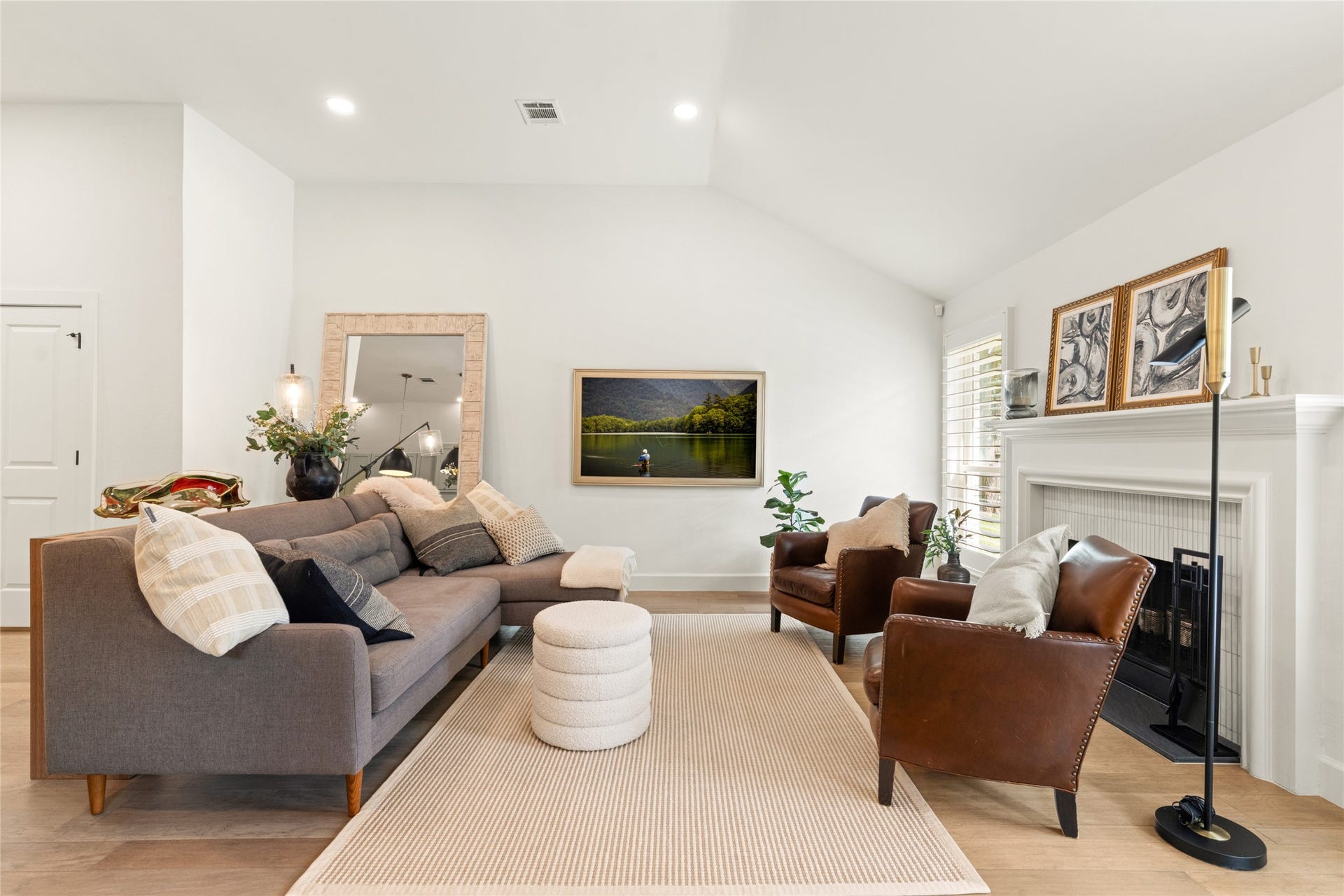 14 Lush Meadow Place, The Woodlands, TX 77381 Vaulted ceilings, warm wood flooring, and a beautiful fireplace create an inviting place to gather.