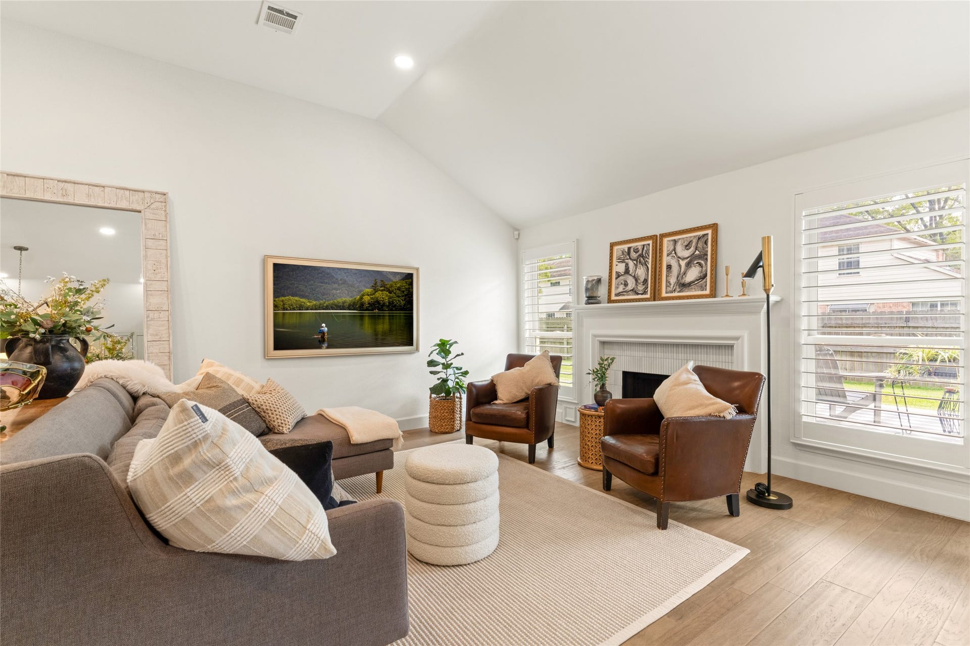 14 Lush Meadow Place, The Woodlands, TX 77381 Plantation shutters bring in natural light while highlighting the room's welcoming atmosphere.