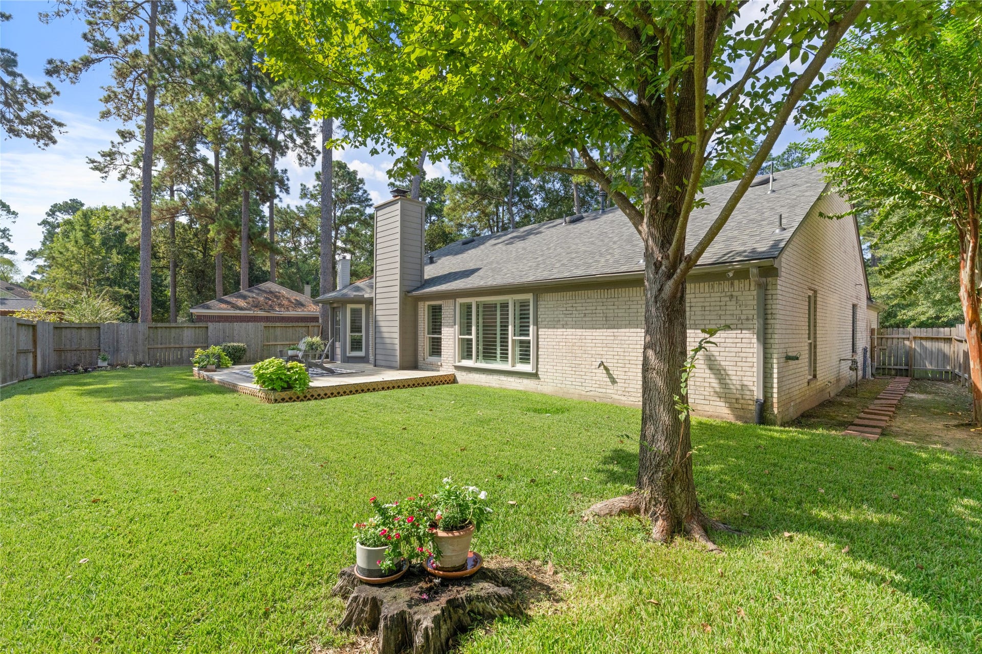14 Lush Meadow Place, The Woodlands, TX 77381 Mature trees, lush lawn, and privacy fencing create a wonderful outdoor retreat.
