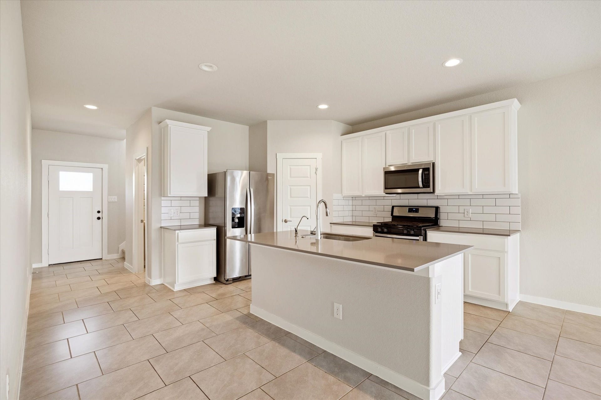 7503 Highland Chase Drive, Richmond, TX 77407 Central island anchors the kitchen with ample prep space, pendant-ready lighting points, and clear sightlines into the main living area.