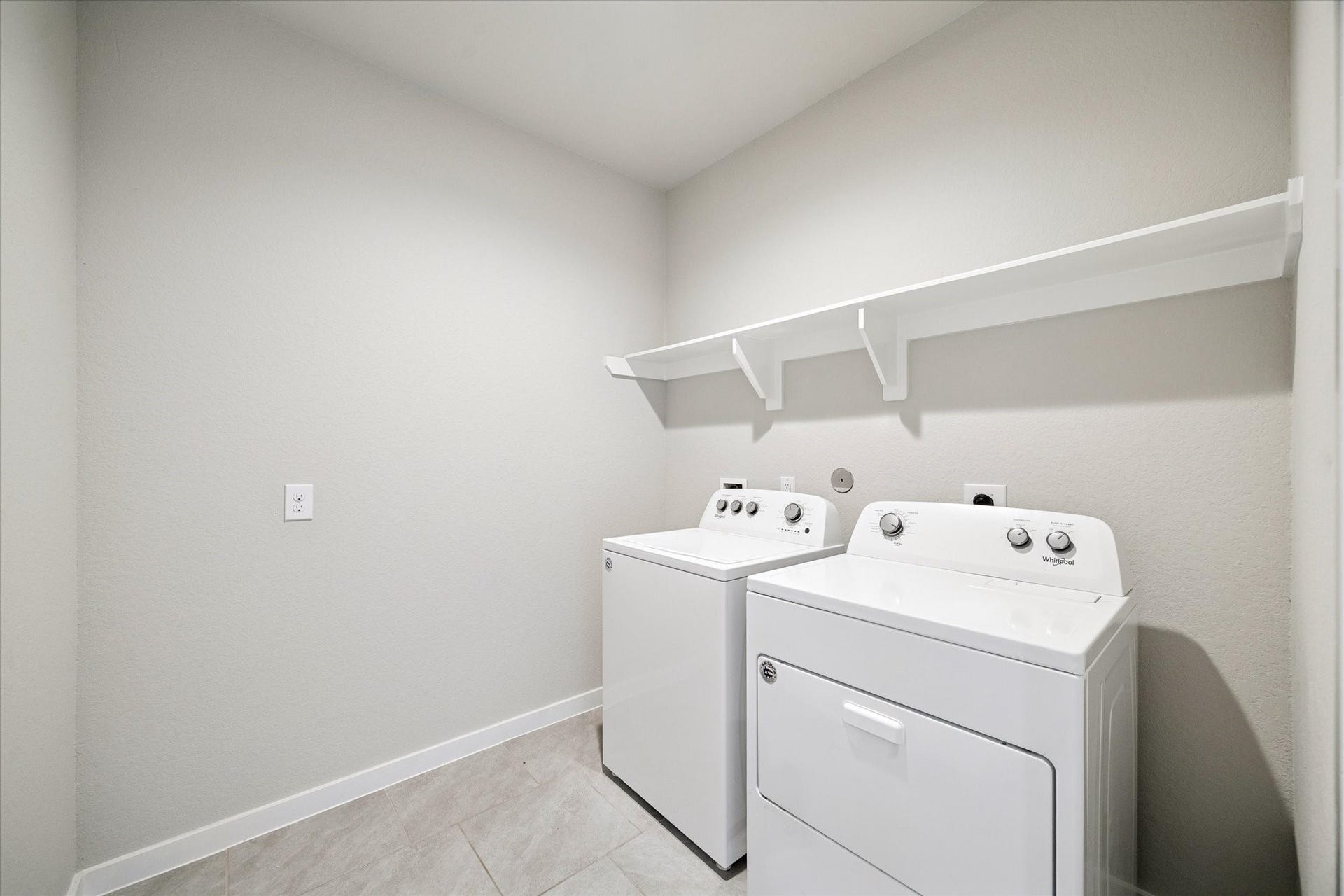 7503 Highland Chase Drive, Richmond, TX 77407 A dedicated laundry room offers a practical, organized workspace with room for full-size appliances and additional storage. Durable flooring and a clean, efficient layout support everyday living while keeping utility spaces thoughtfully separated from main living areas.