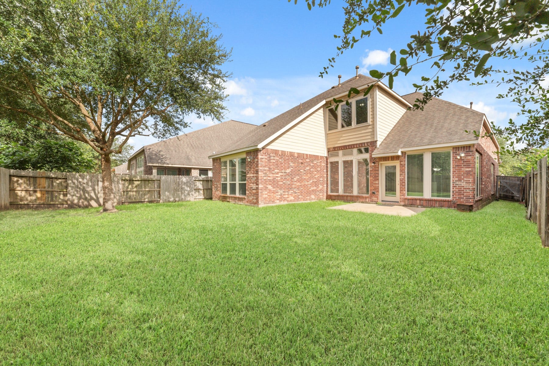 This charming home's back view showcases a spacious patio.