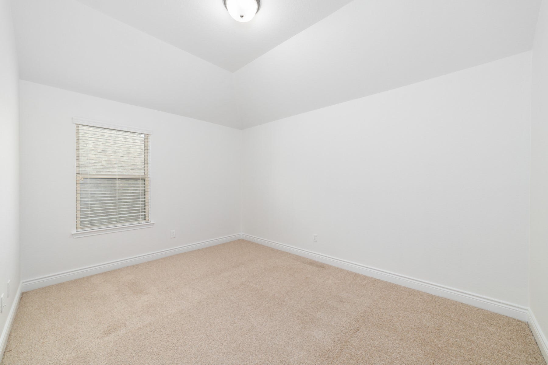 This inviting second bedroom #4 - 
upstairs, featuring soft carpet and a charming sloped ceiling.