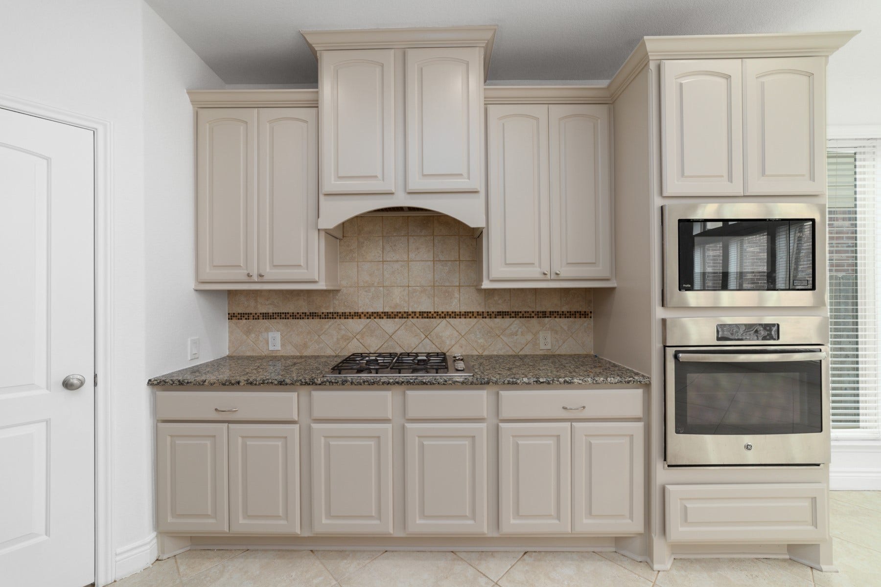 This kitchen is has an abundance of cabinets and a walk in panty.