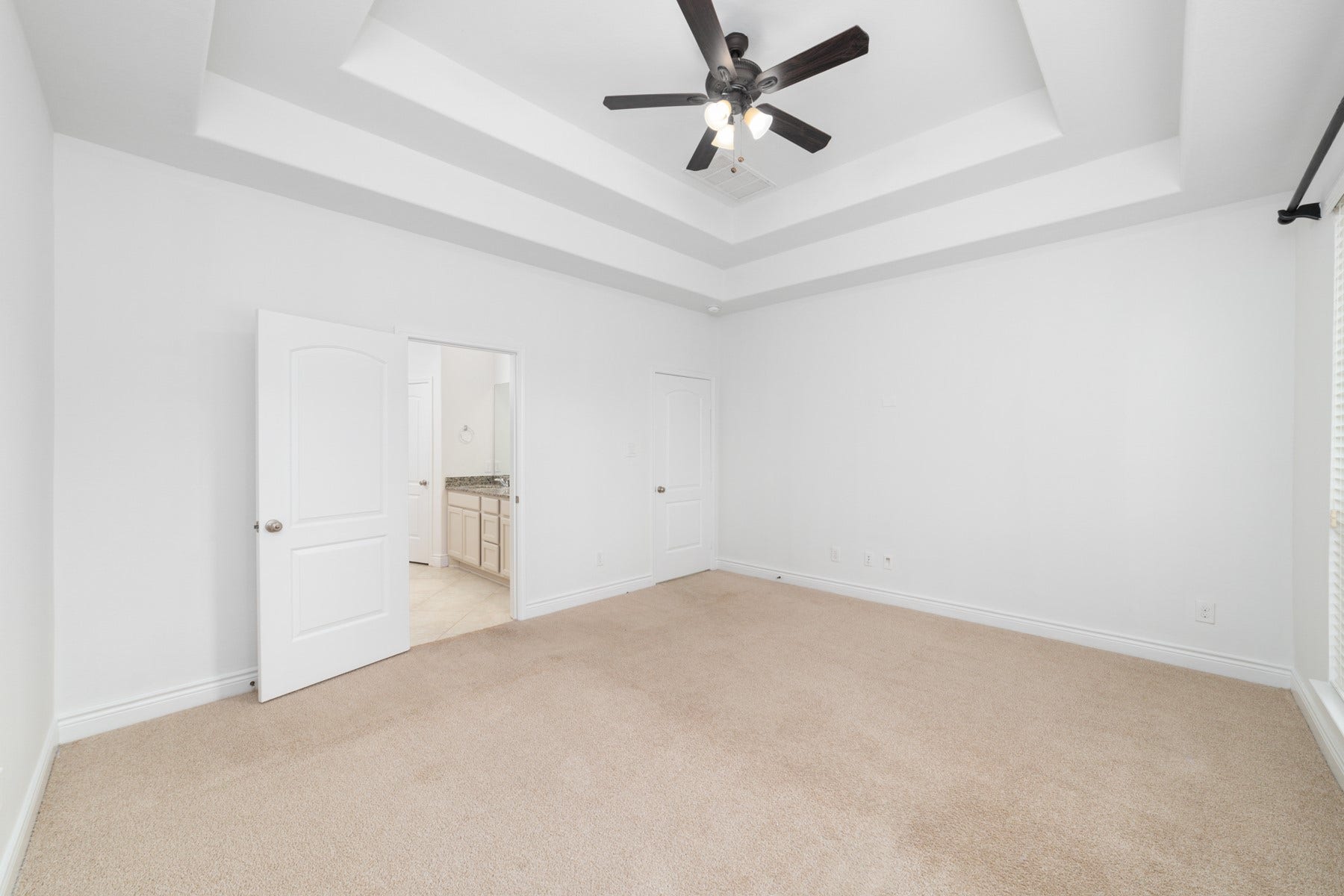Featuring a coffered ceiling and abundant natural light for a serene retreat.