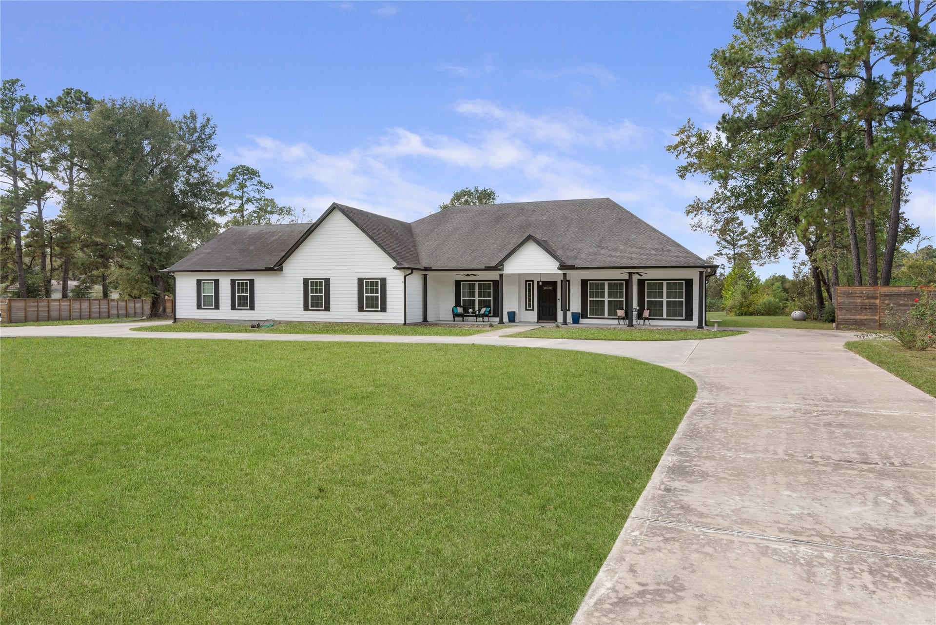 16144 Firetower Road, Conroe, TX 77306 Expansive driveway and generous space alongside the home offer room for additional vehicles, an RV, boat, or trailer.