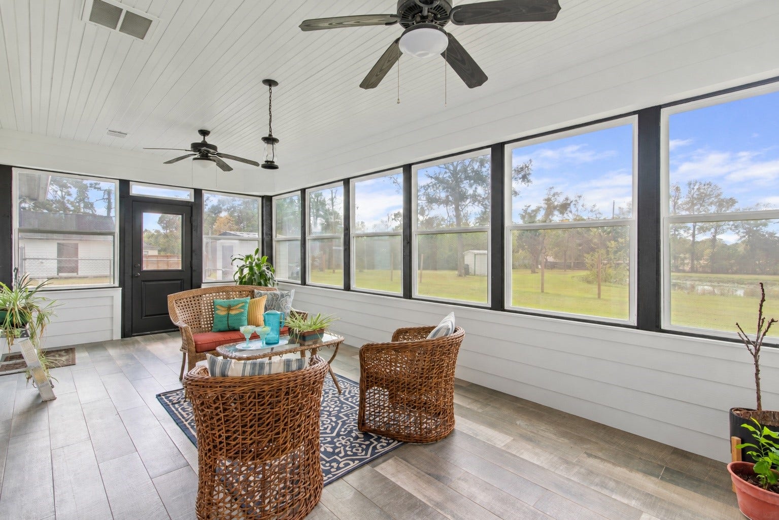16144 Firetower Road, Conroe, TX 77306 Generously sized sunroom with plenty of space for multiple seating areas, perfect for relaxing or gathering with guests while enjoying backyard views.