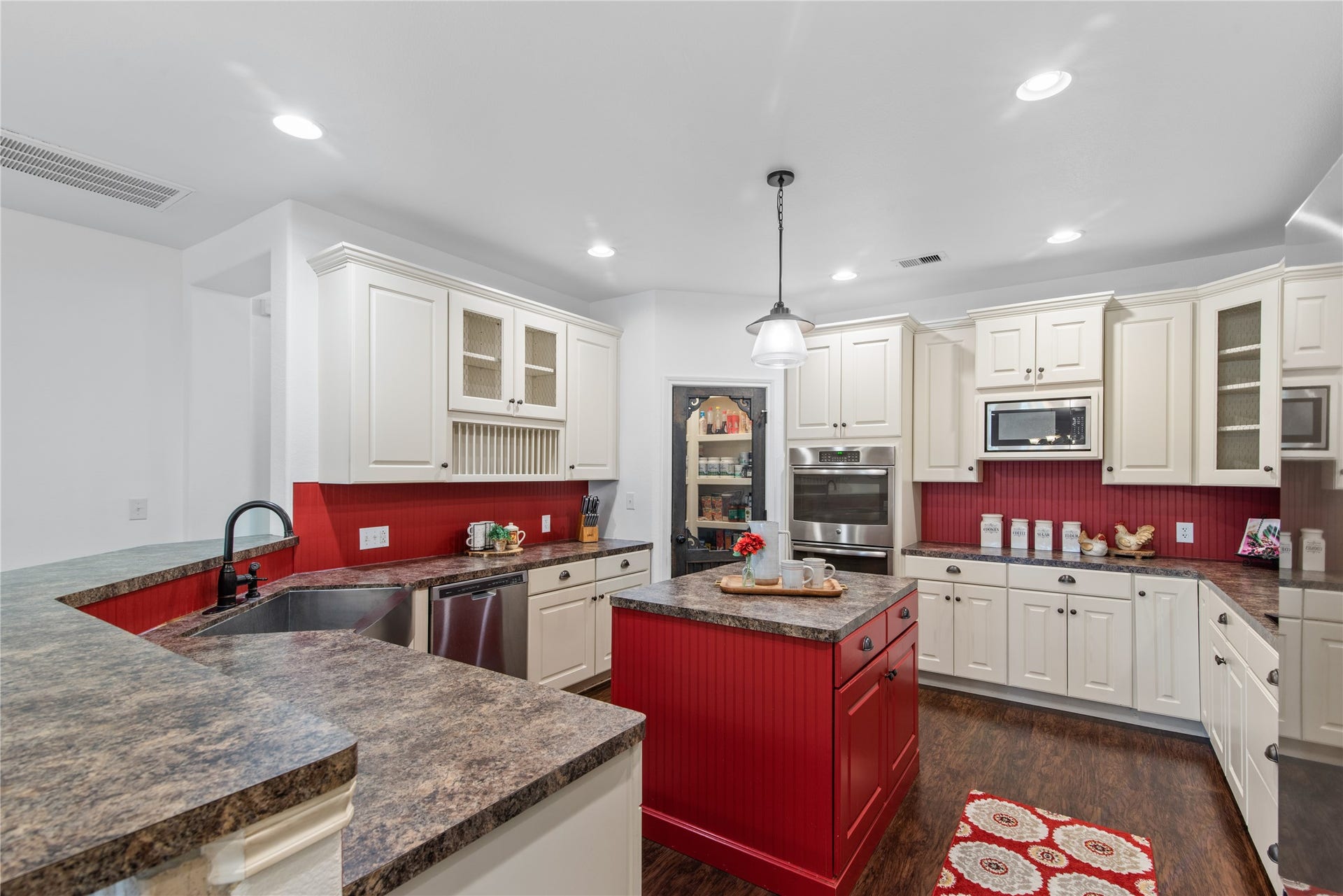 16144 Firetower Road, Conroe, TX 77306 Spacious kitchen featuring abundant cabinetry, a center island, double ovens, and a walk-in pantry.
