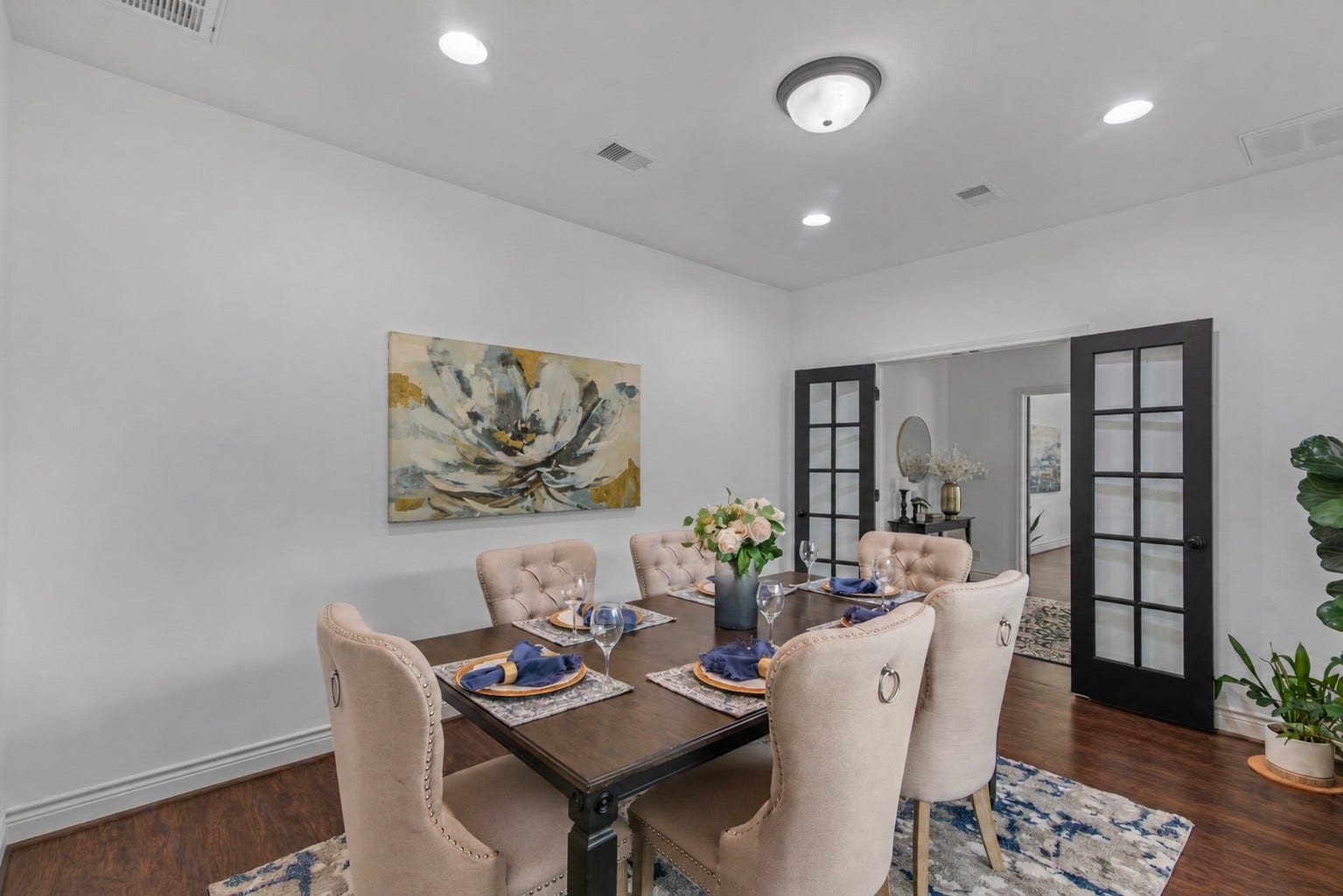16144 Firetower Road, Conroe, TX 77306 French doors connect the formal dining space to the entry, while recessed lighting creates a bright setting for hosting family and friends.