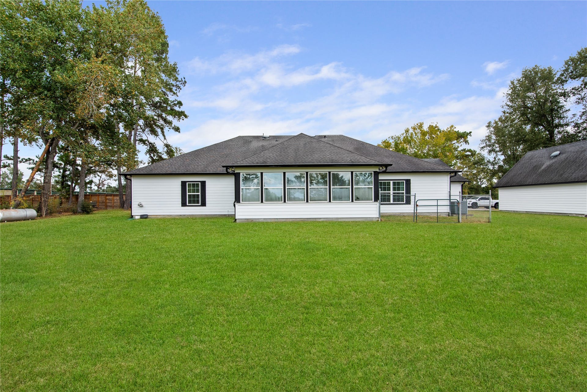 16144 Firetower Road, Conroe, TX 77306 A dedicated pet run provides a separate outdoor space for pets, adding convenience to the spacious backyard.