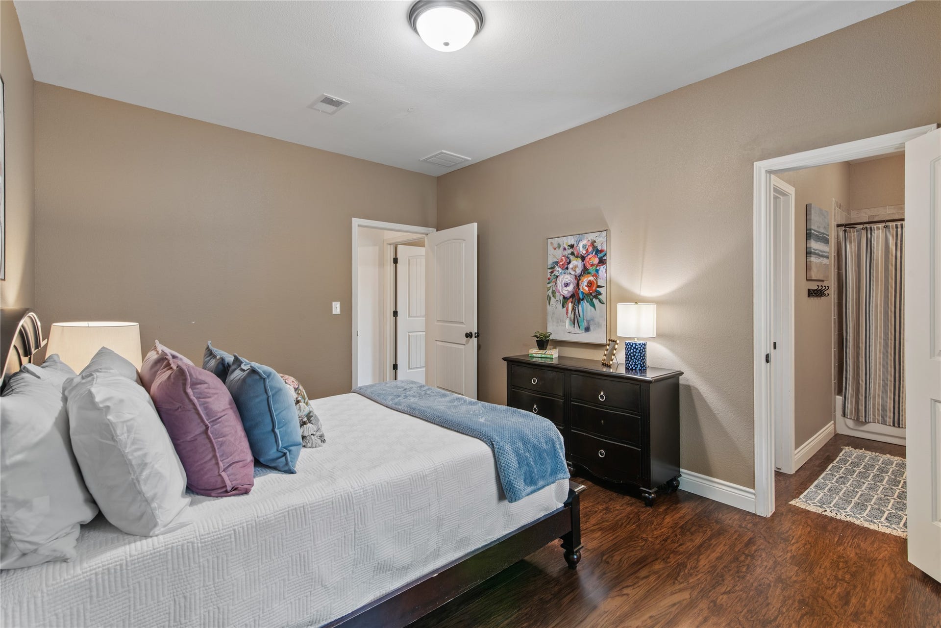 16144 Firetower Road, Conroe, TX 77306 High ceilings, warm neutral tones, and wood-look flooring create an inviting secondary bedroom with plenty of room for additional furnishings.