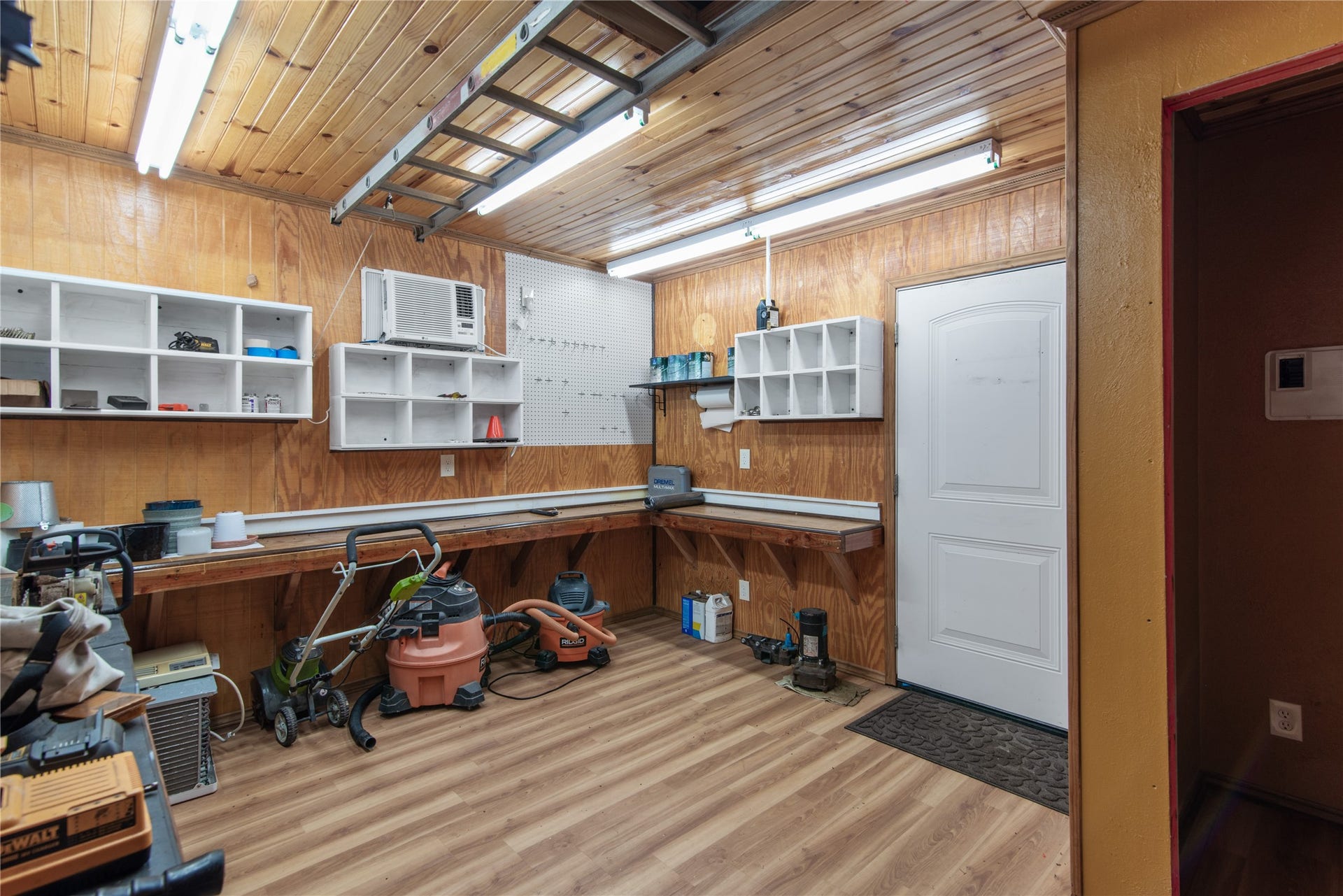 16144 Firetower Road, Conroe, TX 77306 The 15' 11' workshop features A/C, built-in workbenches, shelving, and attic storageideal for hobbies and projects.