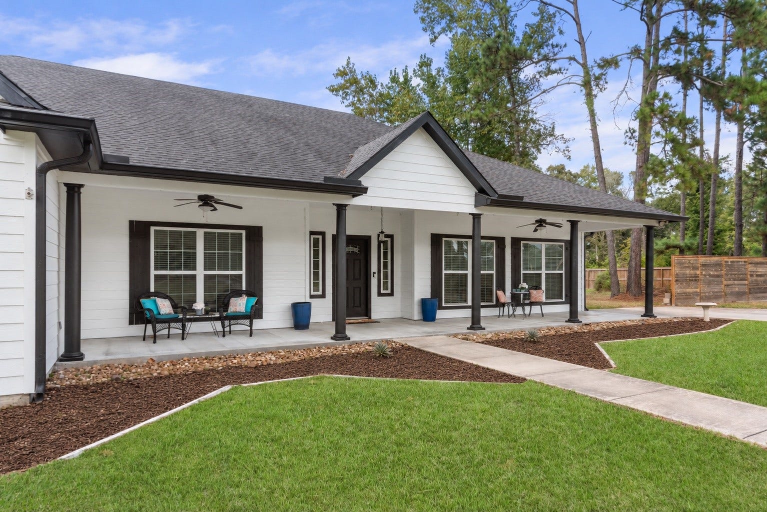 16144 Firetower Road, Conroe, TX 77306 Enjoy morning coffee or unwind on the spacious covered front porch, featuring ceiling fans and plenty of room for multiple seating areas.