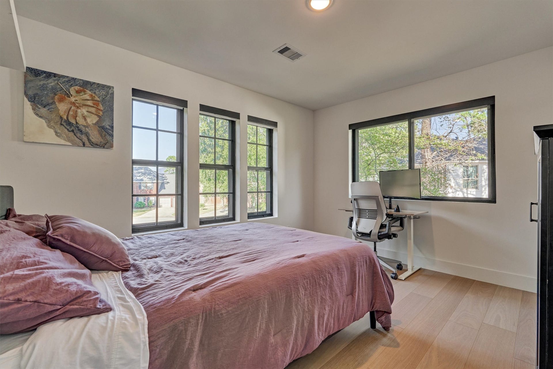 402 Susan Lane, Conroe, TX 77385 Bedroom 3 is generous in size and features white oak flooring and corner views, with custom shades on all windows. No carpet here is ideal for those with allergies!