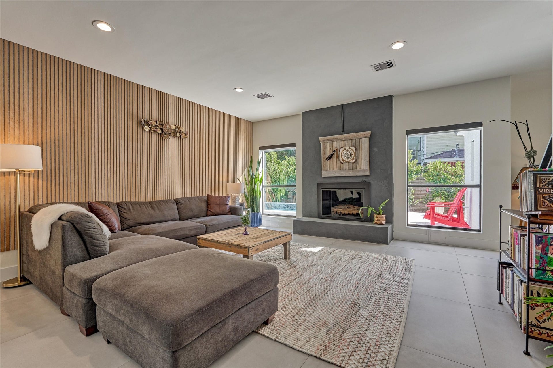 402 Susan Lane, Conroe, TX 77385 Relax in this oversized den with limewash fireplace, custom paneling, and sweeping backyard views!