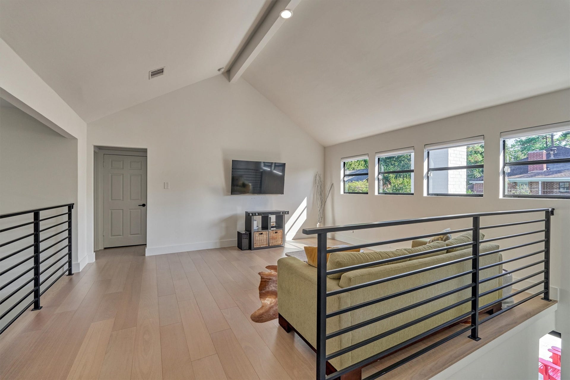 402 Susan Lane, Conroe, TX 77385 Second floor game room with wrought iron railing detail and LED lighting (throughout) is the ideal flex room!