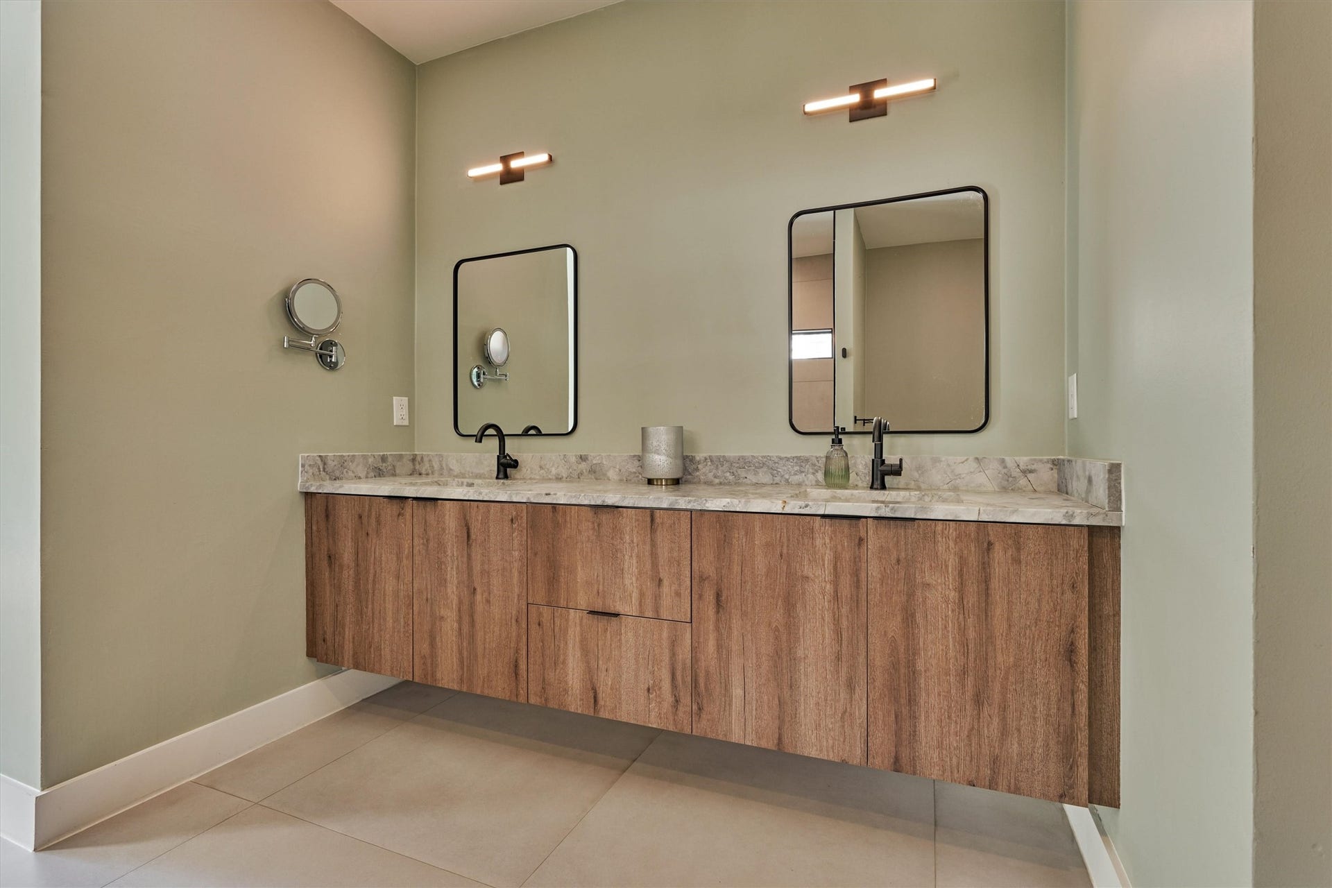 402 Susan Lane, Conroe, TX 77385 Floating vanity with elevated lighting and hardware offers ample storage in this primary bath.