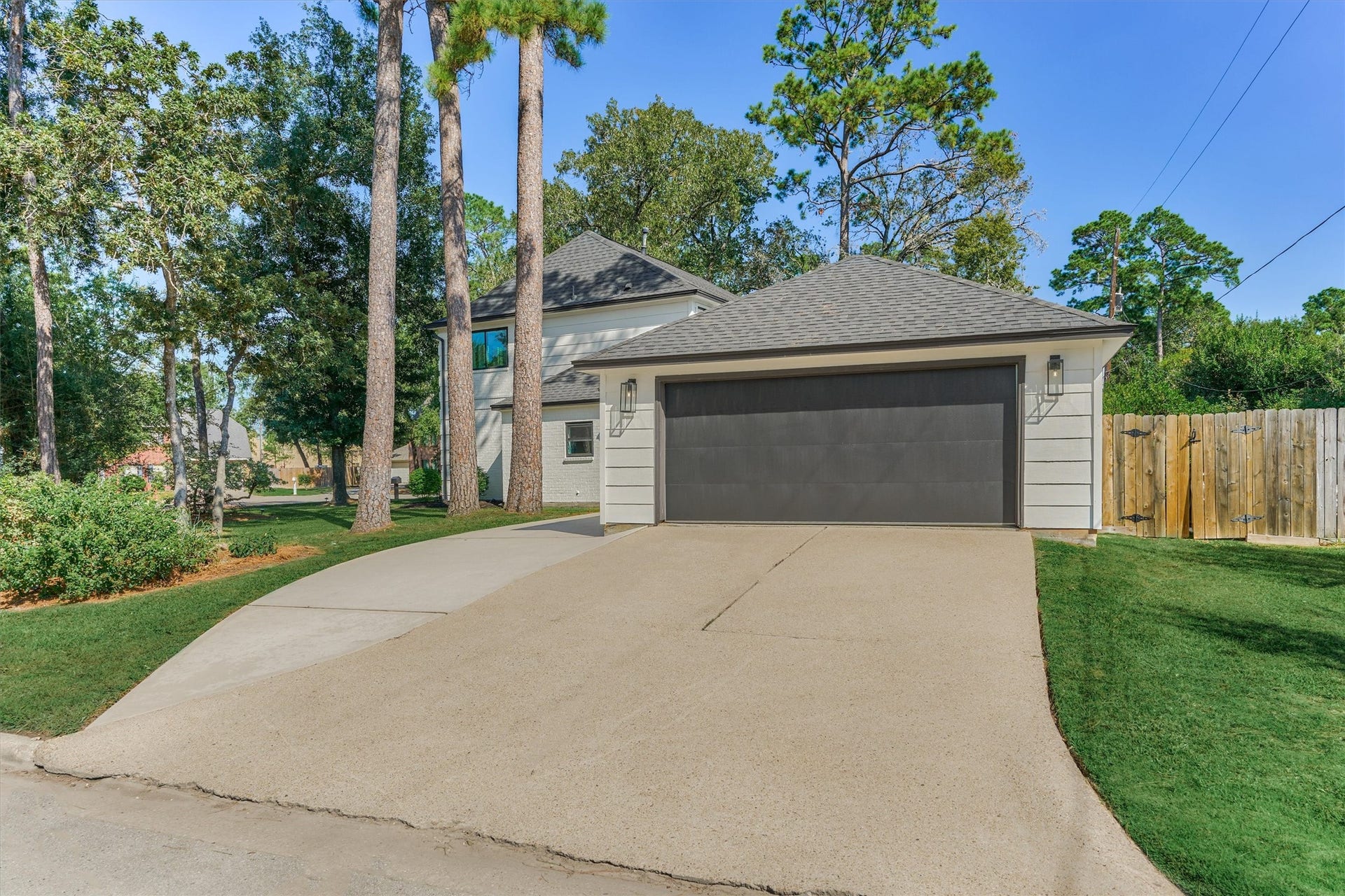 402 Susan Lane, Conroe, TX 77385 Detached garage with side entry on this sprawling corner lot! Bonus storage options inside!