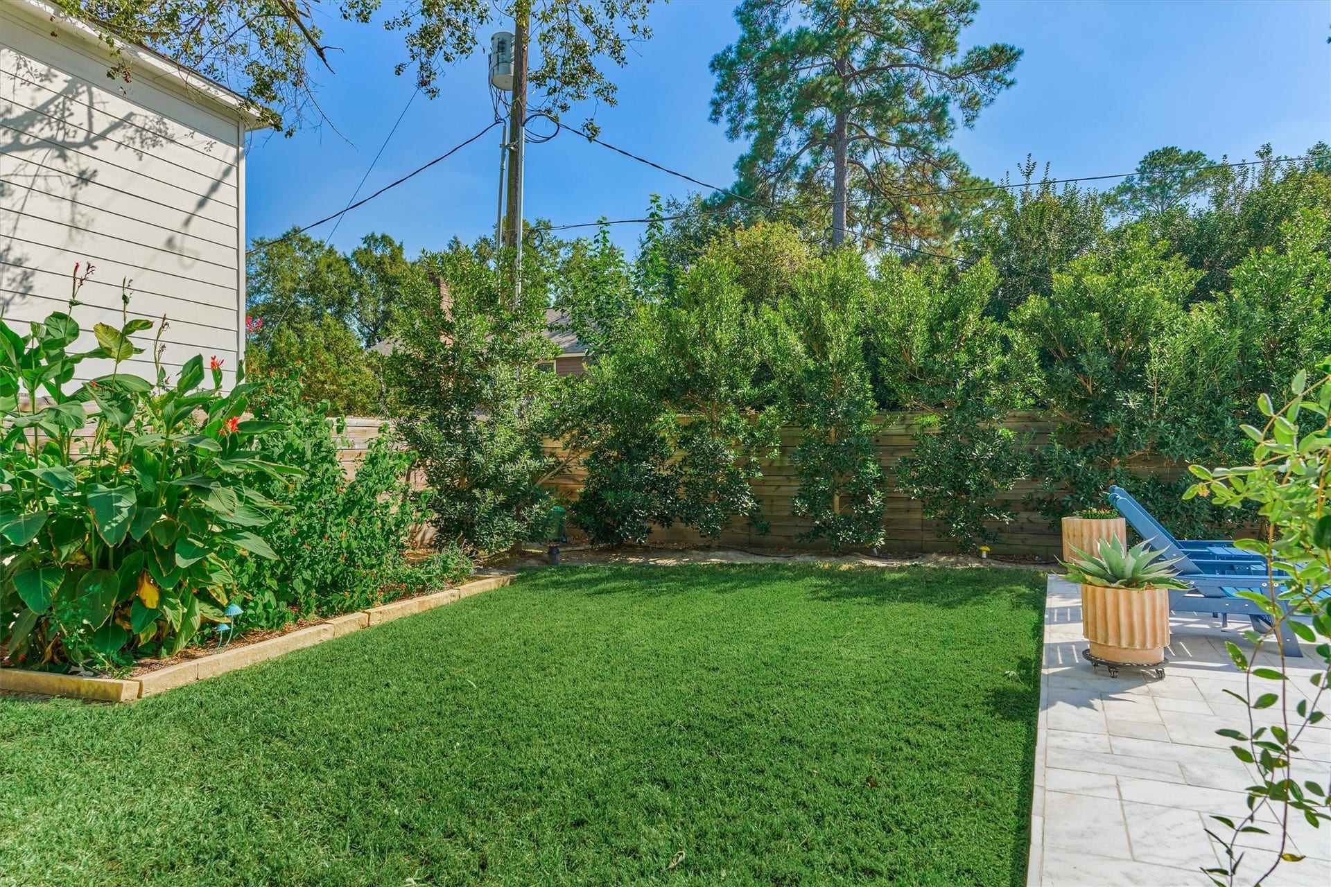402 Susan Lane, Conroe, TX 77385 Raised garden beds with soaking hose adorn the fence line in this private backyard.