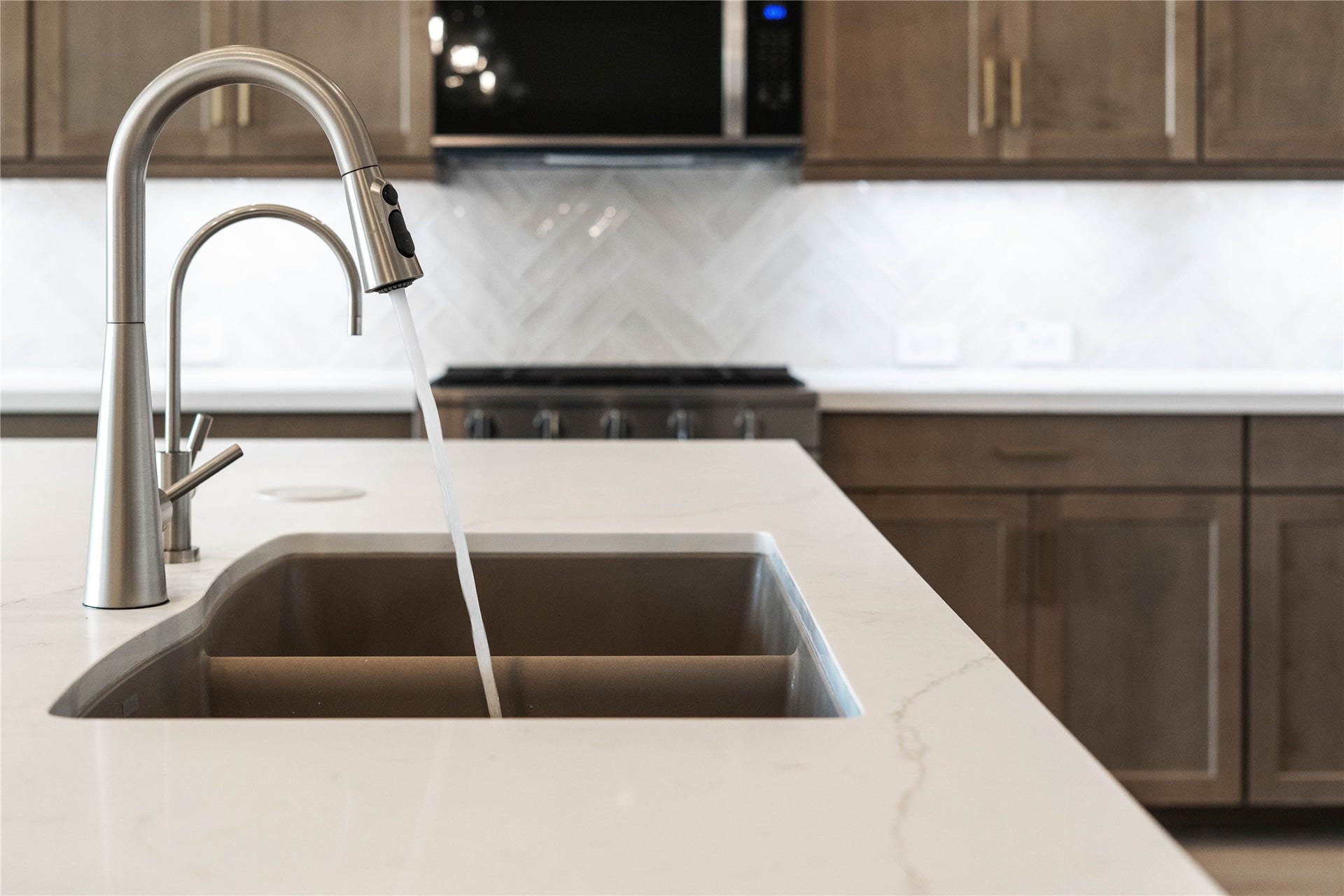The modern stainless steel undermount sink with Contemporary Series faucet and water filtration system.