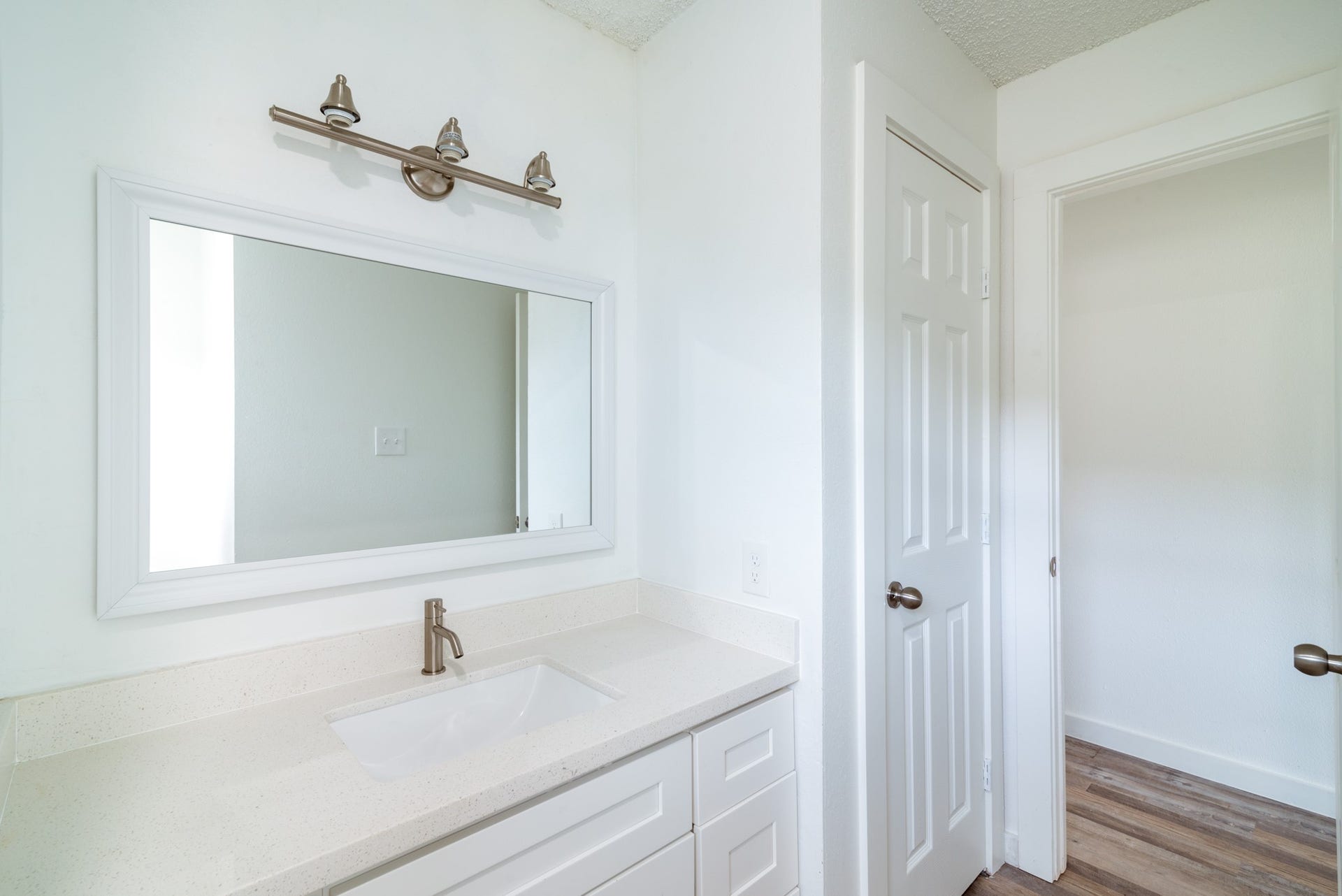 15910 Plagens Lane, Missouri City, TX 77489 Bright and modern bathroom featuring a sleek vanity with a quartz countertop, elegant fixtures, and ample cabinet space.