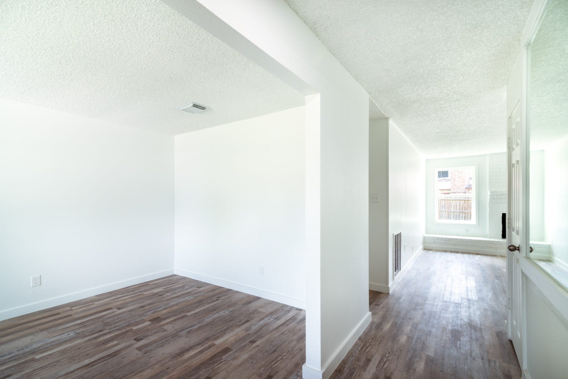 15910 Plagens Lane, Missouri City, TX 77489 Bright and airy interior with fresh white walls and elegant wooden flooring, leading to a sunlit window area perfect for relaxation.