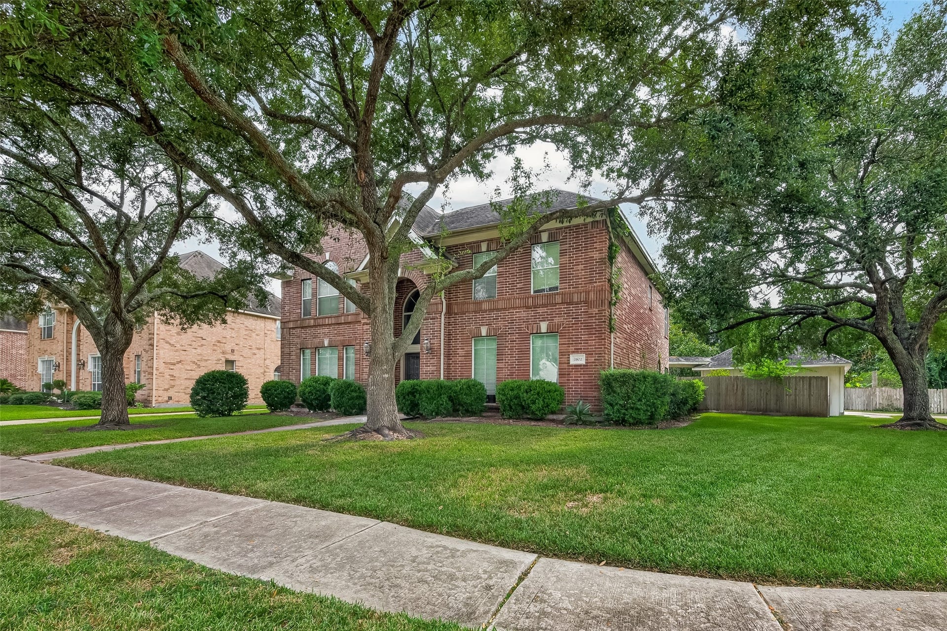 2602 Pinebend Drive, Pearland, TX 77584 The home sits on a prime, oversized corner lot with wraparound sidewalk and curb ramp, offering enhanced accessibility, walkability and easy street-to-property access.