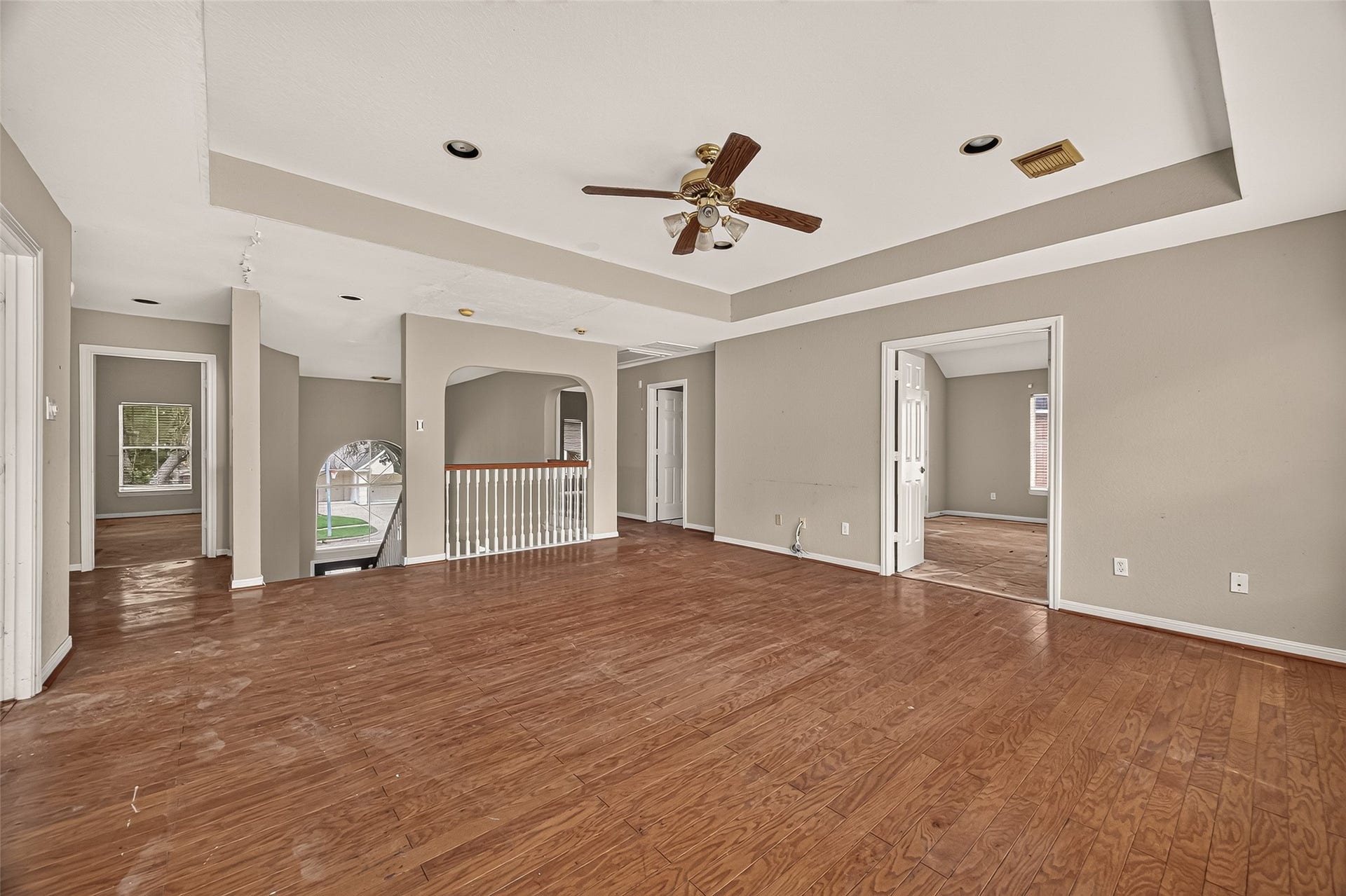 2602 Pinebend Drive, Pearland, TX 77584 This spectacular second-floor game room boasts rich wood flooring, an elegant tray ceiling, and a dramatic overlook to the main level, serving as the perfect central hub to the surrounding upstairs bedrooms