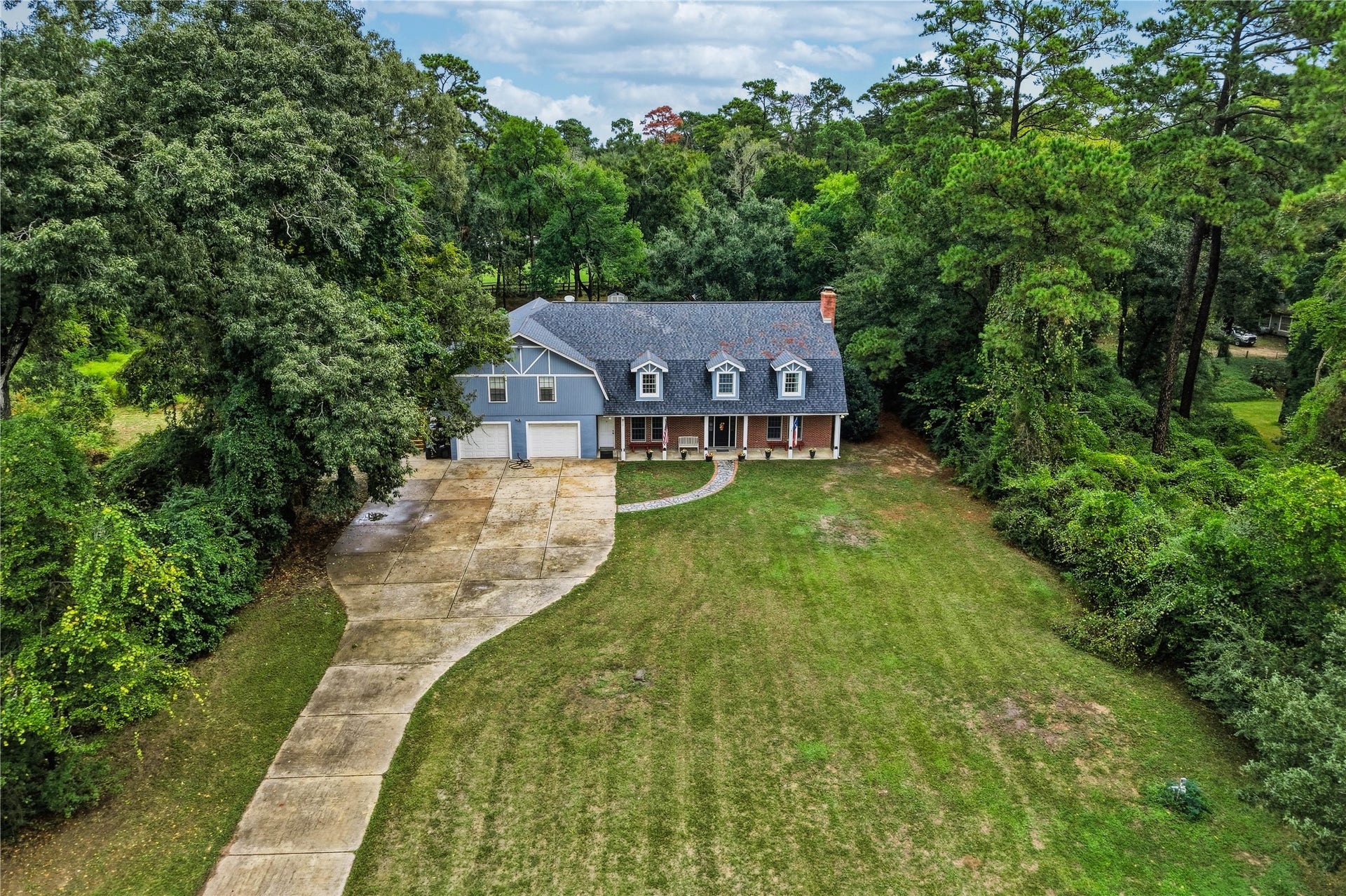 8714 Holly Hills Drive, Tomball, TX 77375 An impressive bird's-eye view of this two-acre property, highlighting the 3,400+ sq ft home with garage 1200+ sq ft apartment and a tandom 6 car garage.