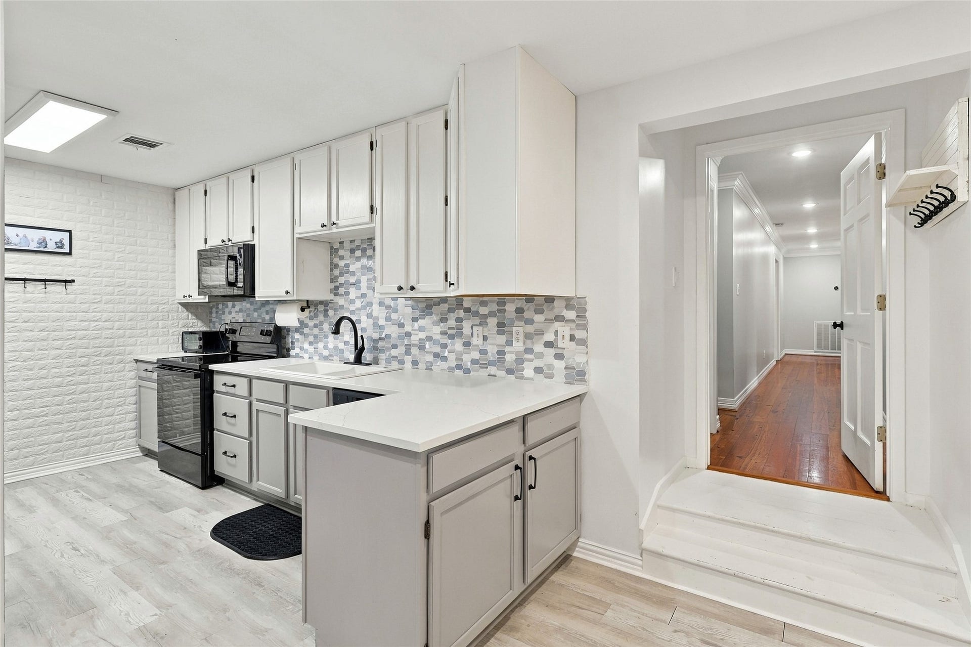 8714 Holly Hills Drive, Tomball, TX 77375 This connected garage apartment boasts an updated full kitchen, complete with attractive two-tone cabinets and a stylish backsplash.