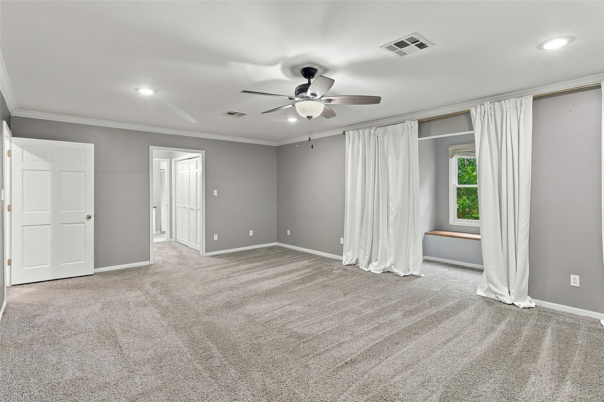 8714 Holly Hills Drive, Tomball, TX 77375 This bright, airy primary bedroom offers ample space to unwind.