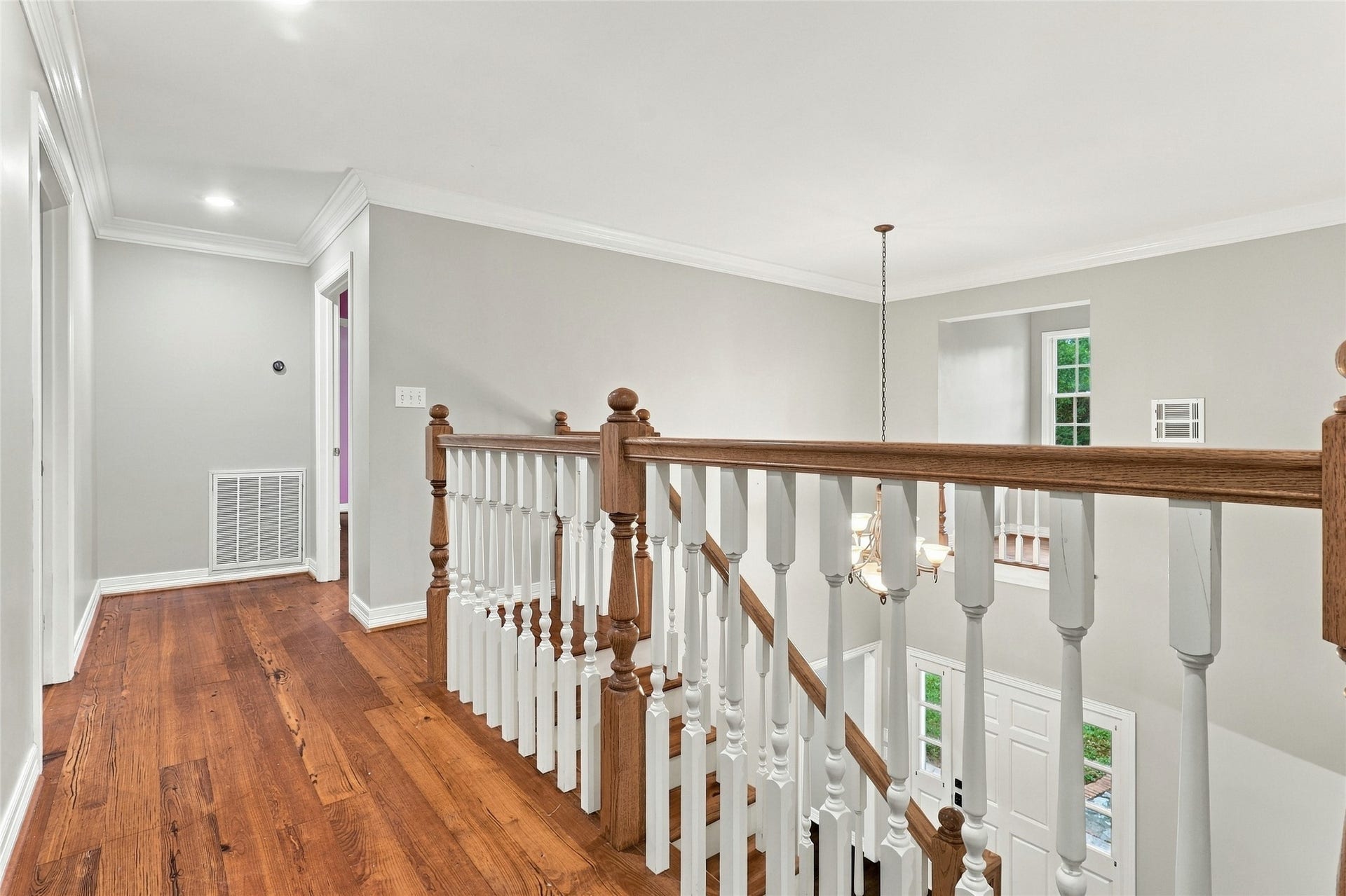 8714 Holly Hills Drive, Tomball, TX 77375 Bright, light-filled upstairs hallway features beautiful wood laminate flooring.