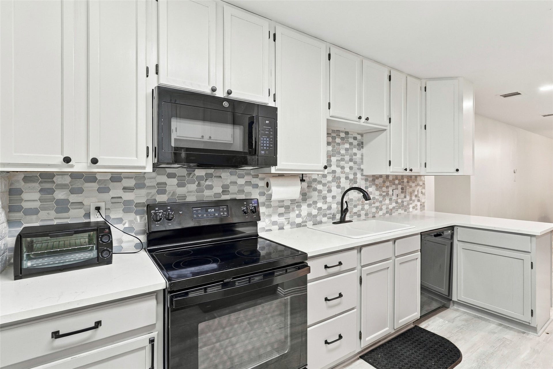 8714 Holly Hills Drive, Tomball, TX 77375 Another angle of this stylish garage apartment kitchen, complete with modern appliances, ample counter space, and decorative backsplash.