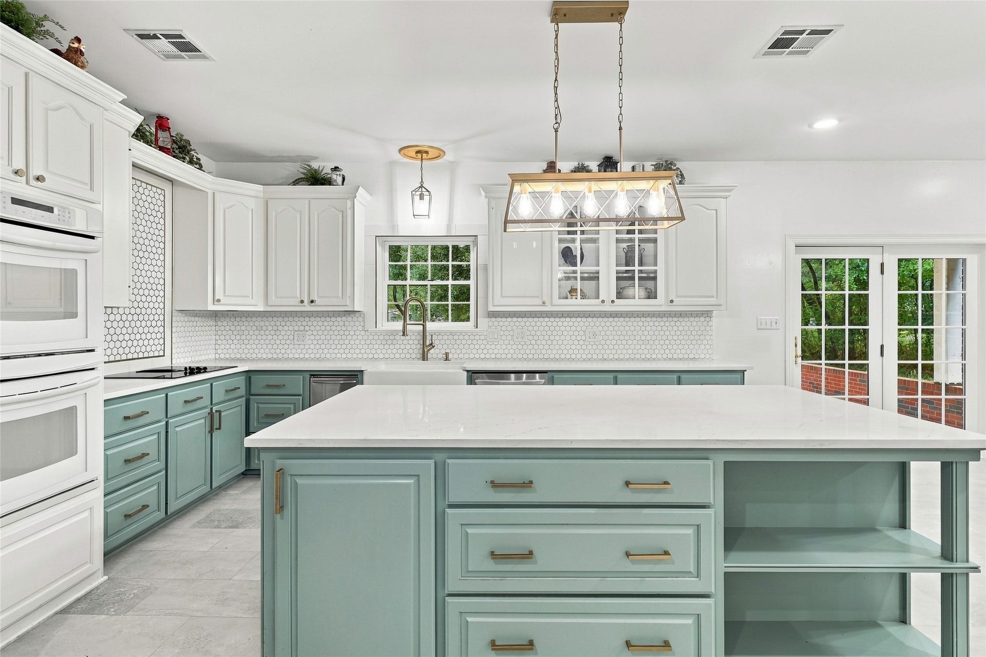 8714 Holly Hills Drive, Tomball, TX 77375 This kitchen is a chef's dream, featuring stunning two-tone cabinetry, a classic farmhouse sink, an elegant backsplash, and beautiful granite countertops.