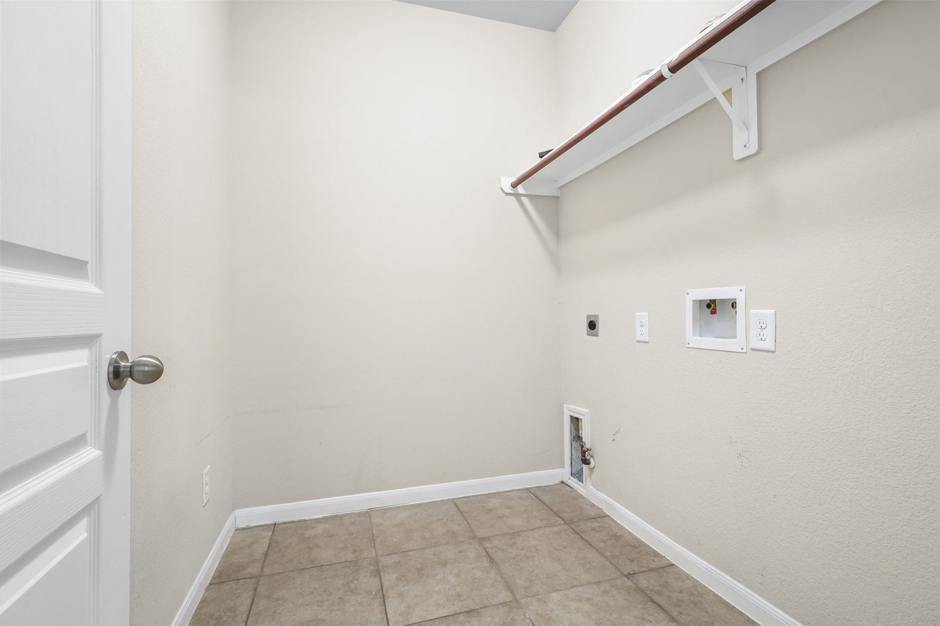9731 Carina Forest Court, Humble, TX 77396 The utility room is designed with everyday function in mind, featuring durable tile flooring, a dedicated washer and dryer area, and an upper storage shelf. Built-in connections and an organized layout make laundry day a little more streamlined.