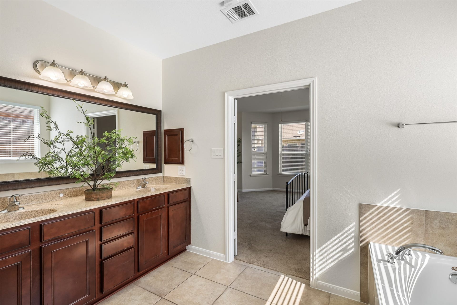 9731 Carina Forest Court, Humble, TX 77396 The primary vanity offers plenty of room to spread out, with dual sinks, generous cabinetry, and ample counter space. The large framed mirror and natural light keep the space feeling bright and open while providing the storage and functionality a busy morning routine calls for.