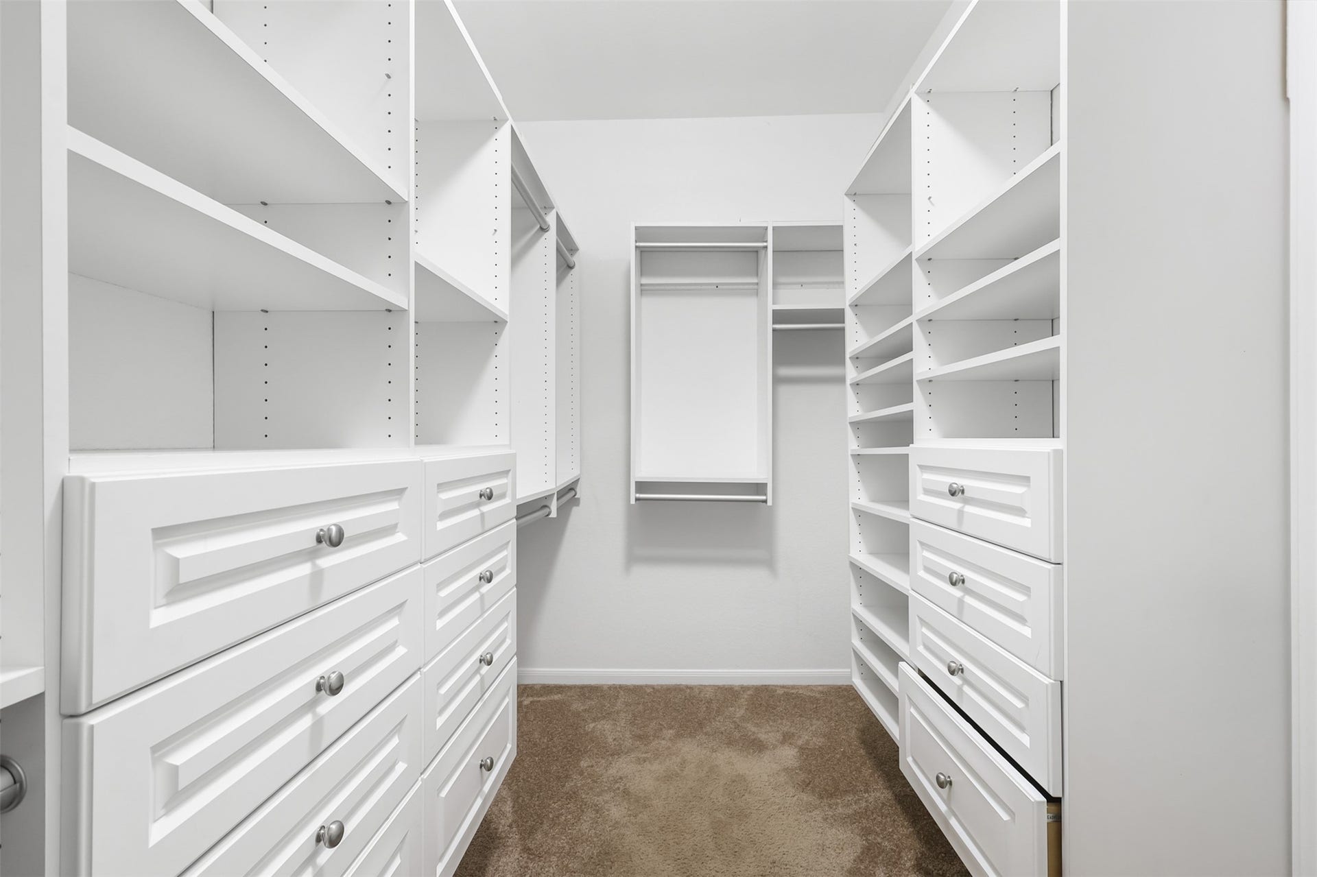 9731 Carina Forest Court, Humble, TX 77396 Just beyond the primary bath, the oversized walk-in closet delivers serious organization. Built-in drawers, shelving, and multiple hanging areas provide a dedicated place for everything, making it easy to keep the primary suite feeling calm and clutter-free.