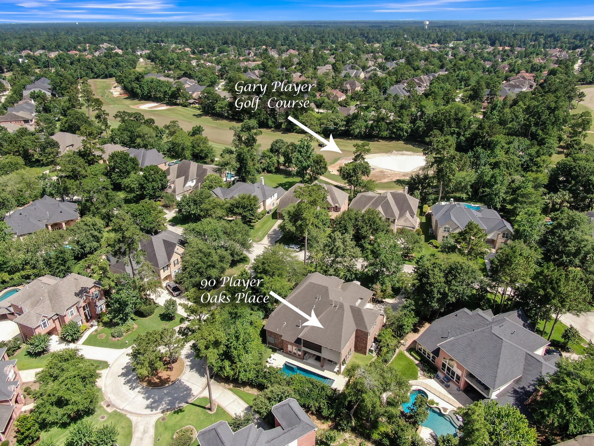 Elevated neighborhood view illustrating the prime location of 90 Player Oaks Pl. Tucked away in a peaceful cul-de-sac surrounded by a dense tree canopy, this property offers exceptional privacy with direct, close proximity to the Woodlands Country Club Gary Player Course.