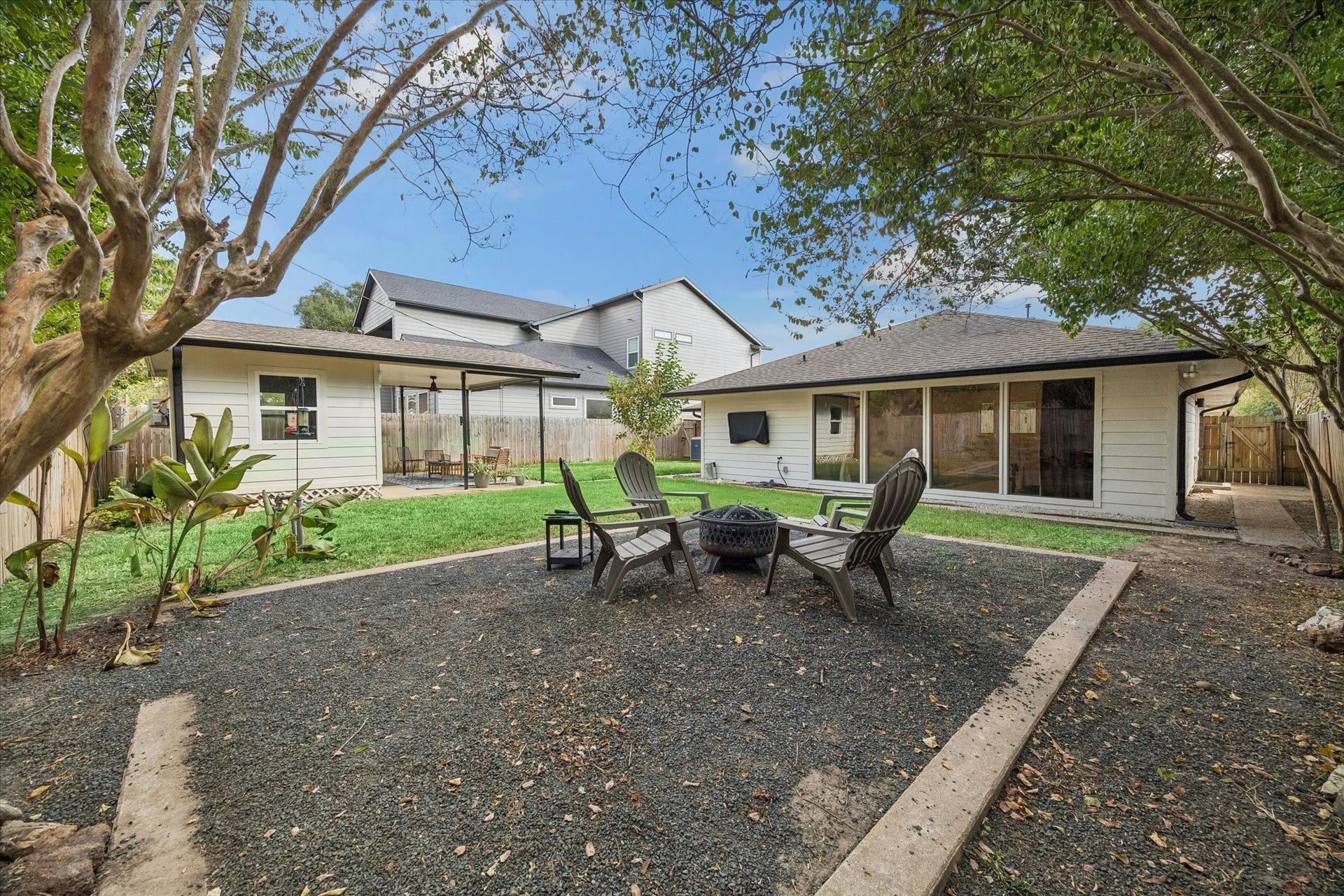 2018 Libbey Drive, Houston, TX 77018 Anchored by a dedicated fire pit area beneath mature shade trees, the backyard is made for relaxed evenings, conversation and gathering outdoors.