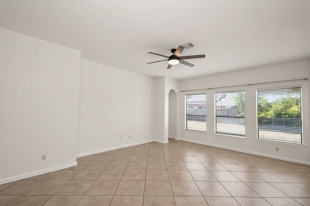 14903 Meridian Park Lane, Humble, TX 77396 The living room offers a wall of windows and brings in abundant natural light.