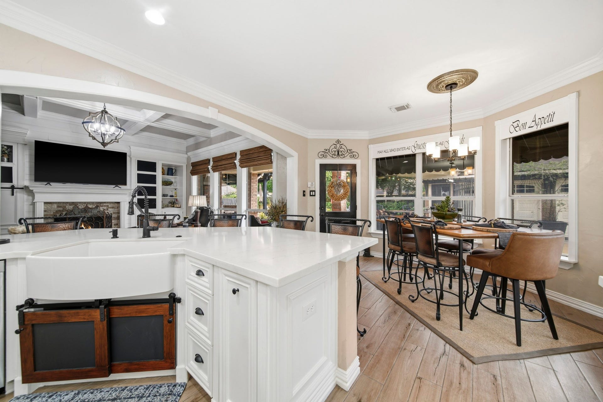 20303 Silverwood Trail, Cypress, TX 77433 Kitchen featuring quartz countertops, a farmhouse sink, and antique bronze fixtures, blending timeless charm with everyday functionality.