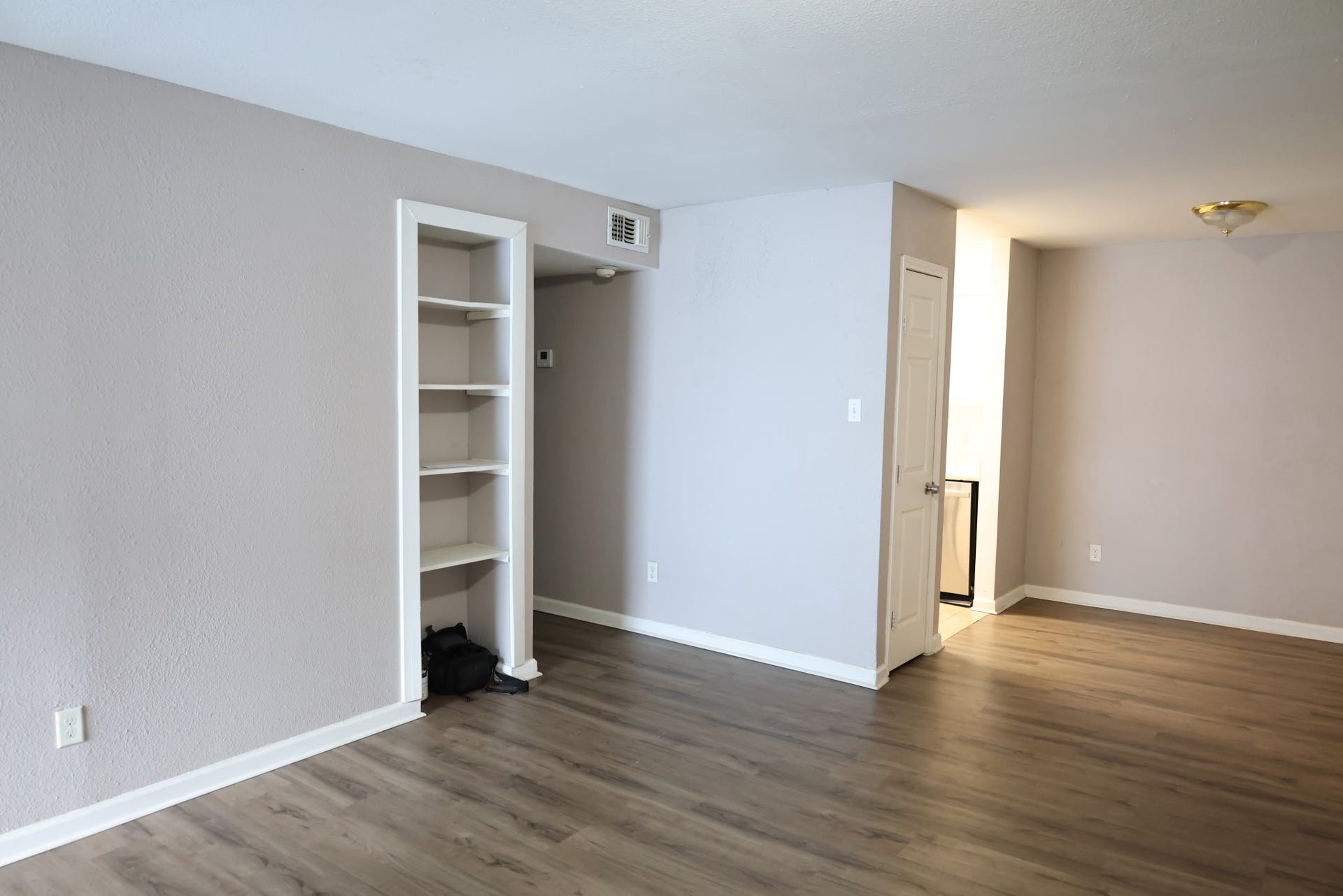 5625 Antoine Drive, #1314, Houston, TX 77091 The main living area features wood-look flooring, neutral finishes and built-in display shelving.