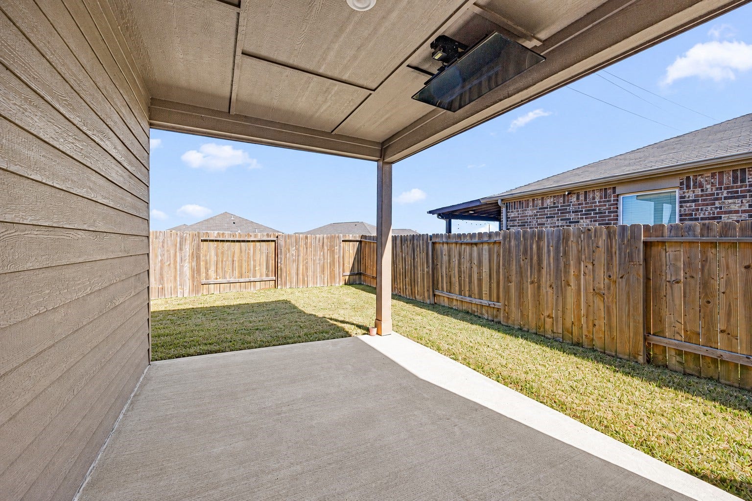 Covered Patio Featuring a Remote-Controlled, Motorized Drop-Down TV. (view 2)
