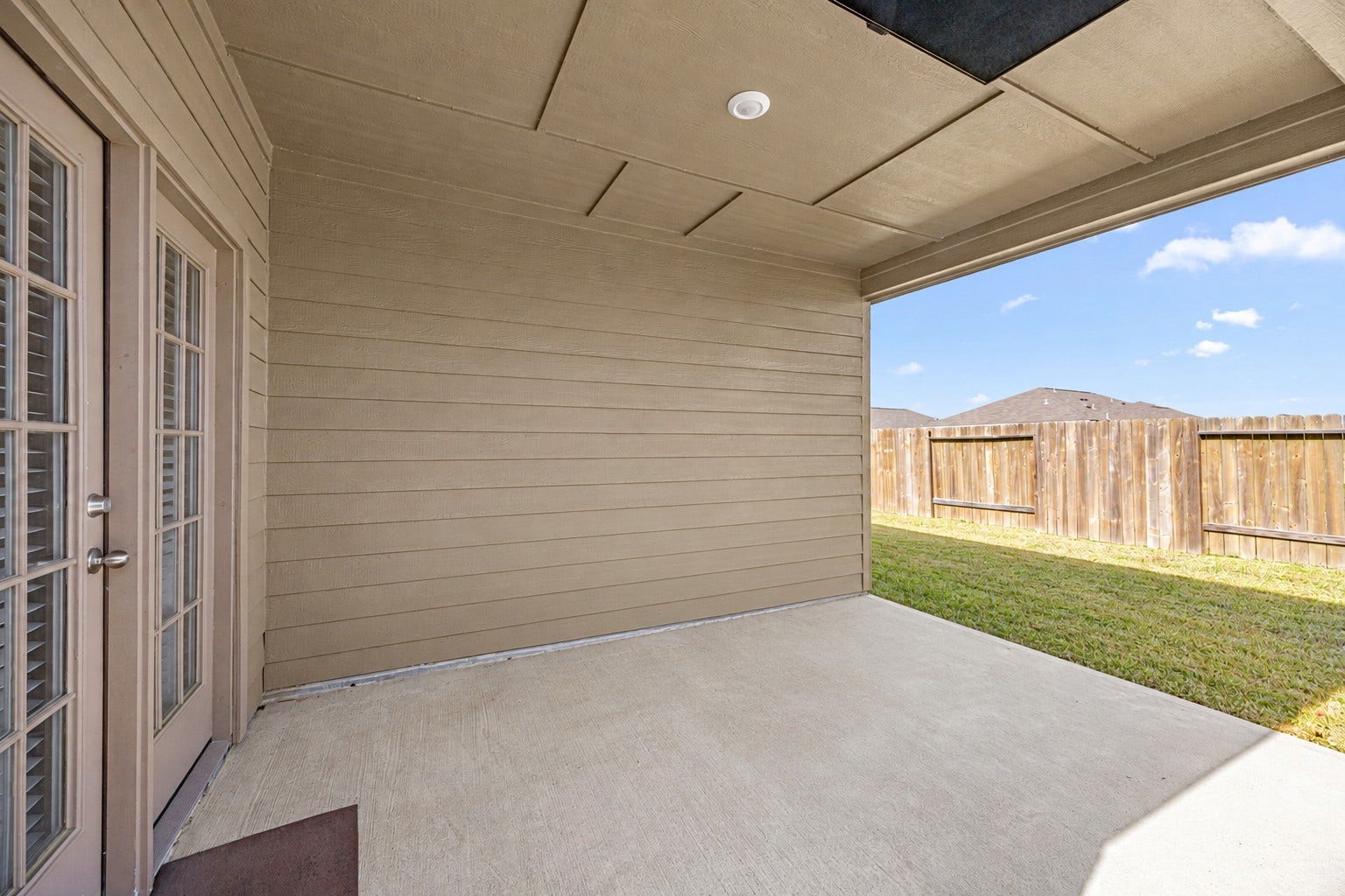 Covered Patio Featuring a Remote-Controlled, Motorized Drop-Down TV.