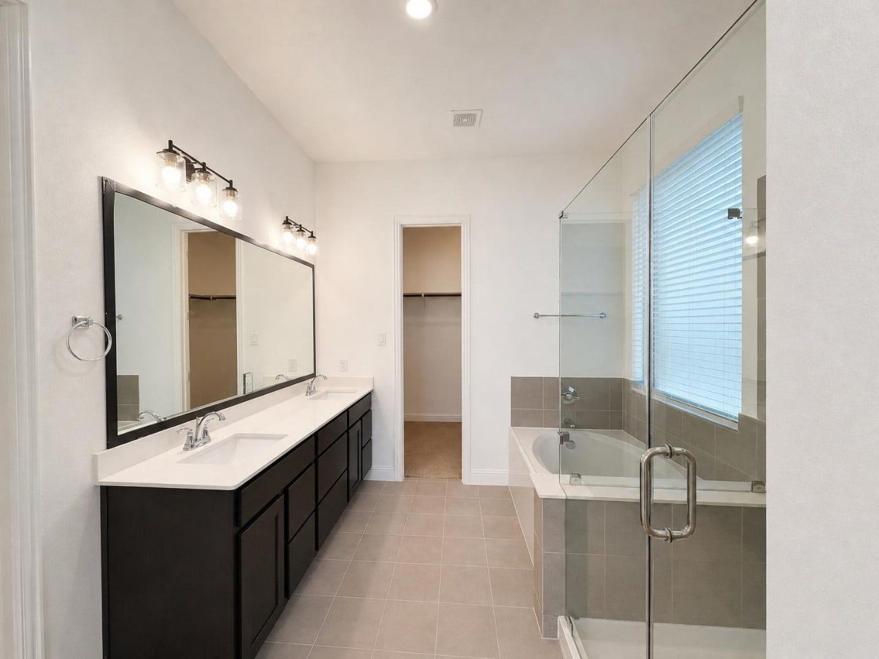 2004 Terra Rose Drive, Katy, TX 77493 Primary suite includes a separate garden tub and shower, double sinks, a privacy door on the commode, and a large walk in closet.