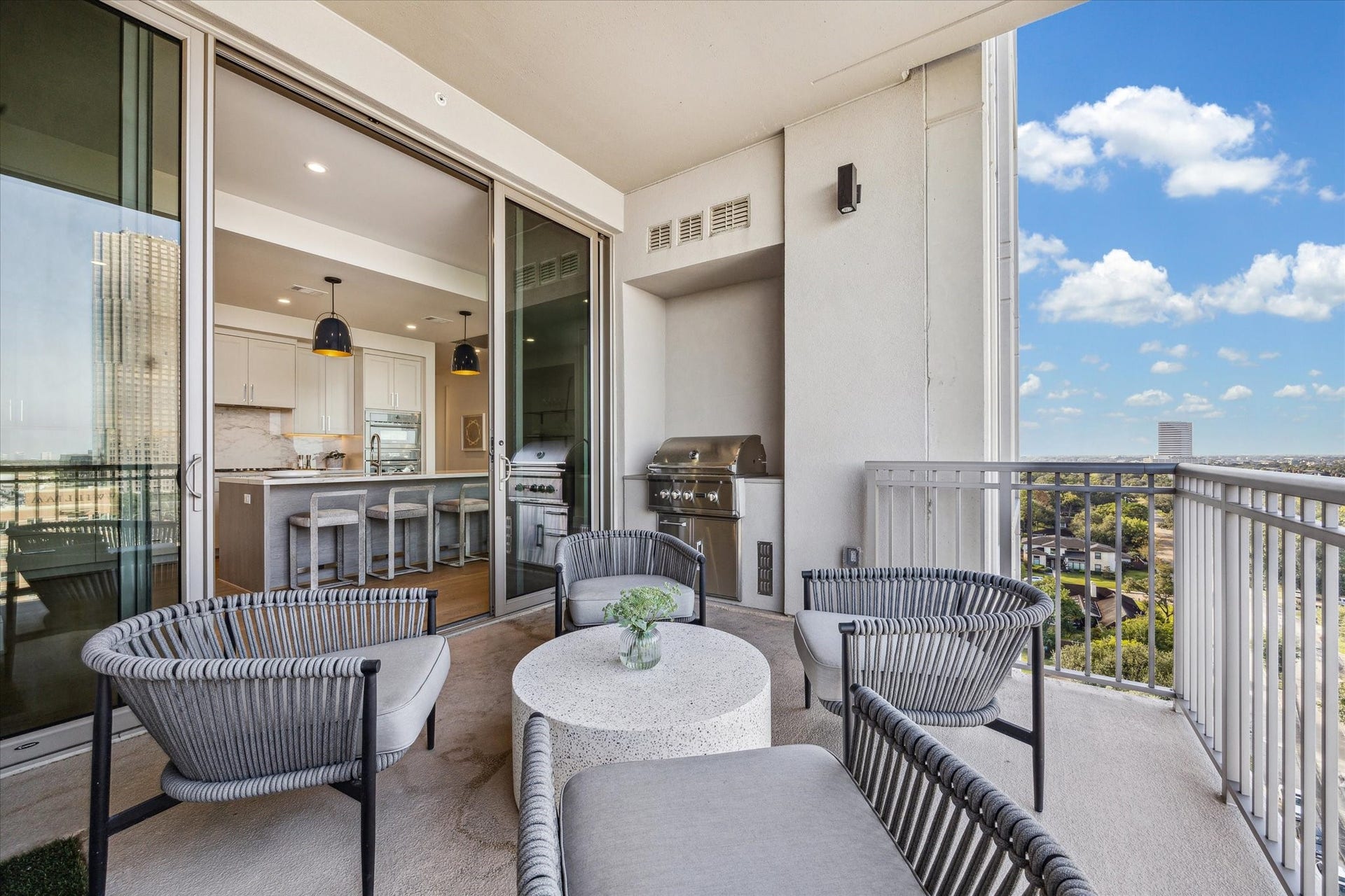 5656 San Felipe Street, #1005, Houston, TX 77056 Balcony shown with sliding doors open to the kitchen for seamless indooroutdoor living. Photos are of a similar unit with the same floor plan
