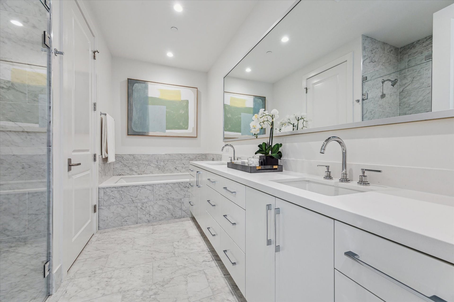 5656 San Felipe Street, #1005, Houston, TX 77056 Primary bathroom with dual sinks, quartz counter-top, soaking tub, glass-framed walk-in shower, linen closet, private water-closet and a large walk-in dressing room. Photos are of a similar unit with the same floor plan