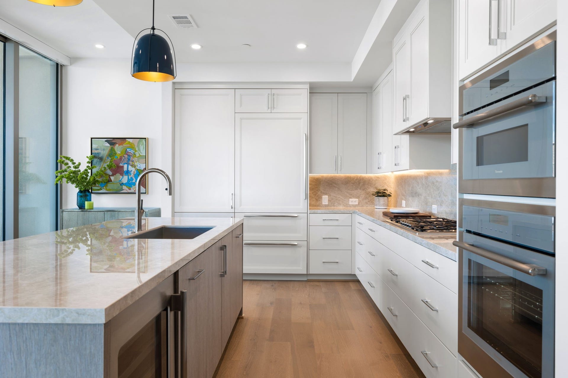 5656 San Felipe Street, #1005, Houston, TX 77056 Abundant storage space with custom-built soft closing cabinetry and drawers, Thermador appliances, wine chiller and sub-zero refrigerator with two freezer drawers. Photos are of a similar unit with the same floor plan