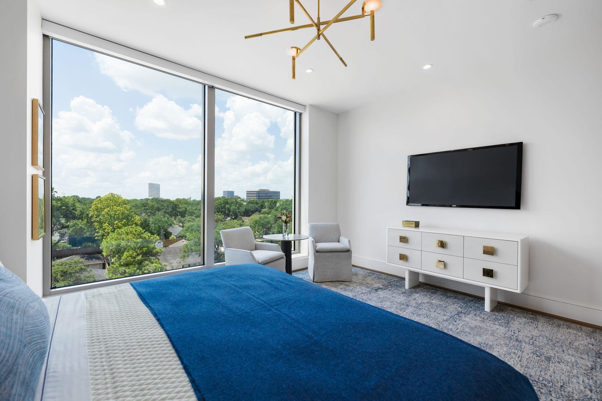 5656 San Felipe Street, #1005, Houston, TX 77056 Another perspective of the primary bedroom with sitting area, highlights the views through floor to ceiling windows. Photos are of a similar unit with the same floor plan