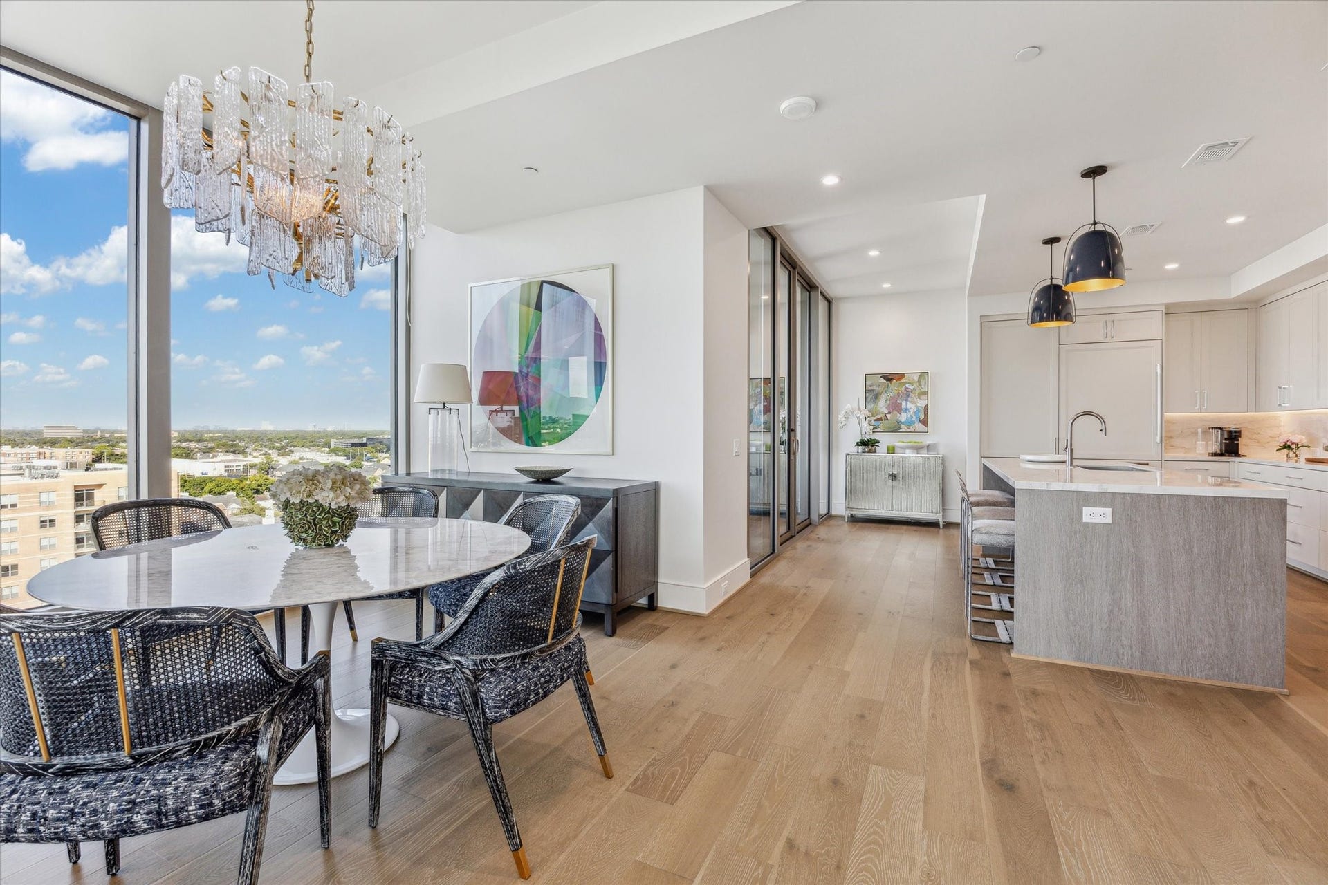 5656 San Felipe Street, #1005, Houston, TX 77056 Open-concept layout where the living area transitions effortlessly into the dining and kitchen spaces. Photos are of a similar unit with the same floor plan